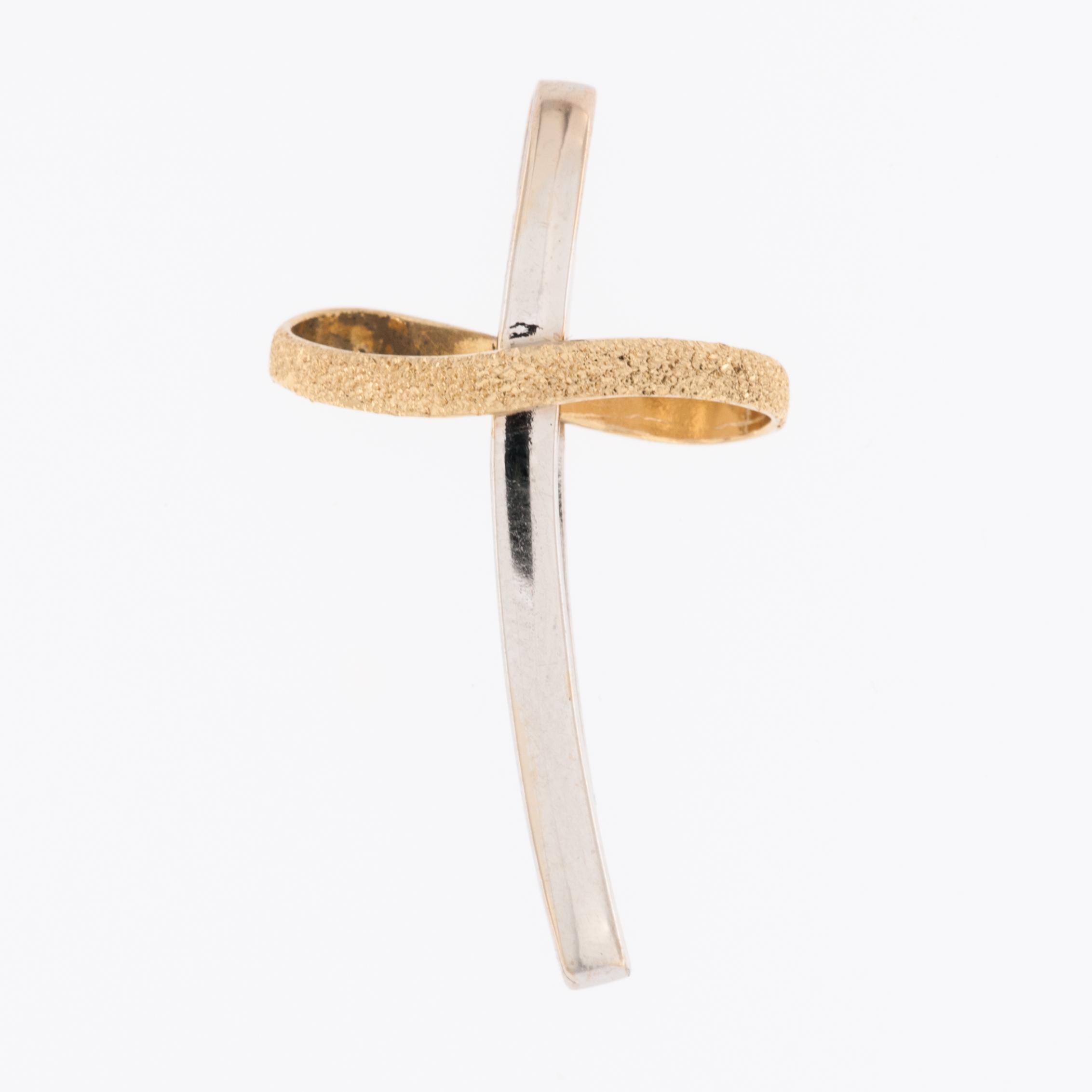 The Italian 18kt Yellow and White Gold Cross is a piece of jewelry that combines the beauty of two different gold colors, yellow and white, to create a stunning and meaningful symbol of faith. 

This cross is crafted from 18 karat gold, which