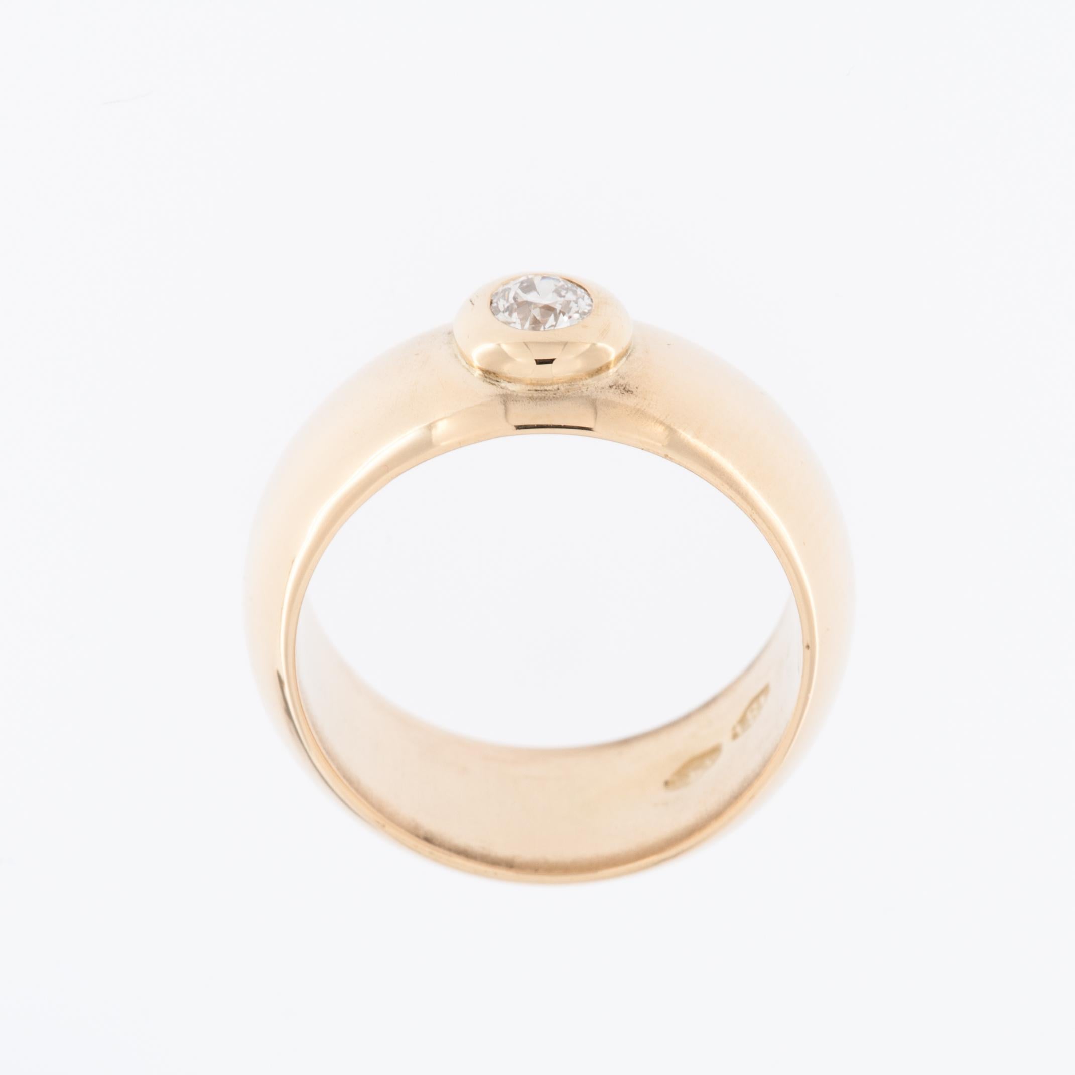 The Italian 18kt Yellow Gold Band Ring with Diamond bezel setting is a luxurious and elegant piece of jewelry.

The ring is crafted from high-quality 18-karat yellow gold, which is known for its rich, warm color and durability. Italian jewelry is