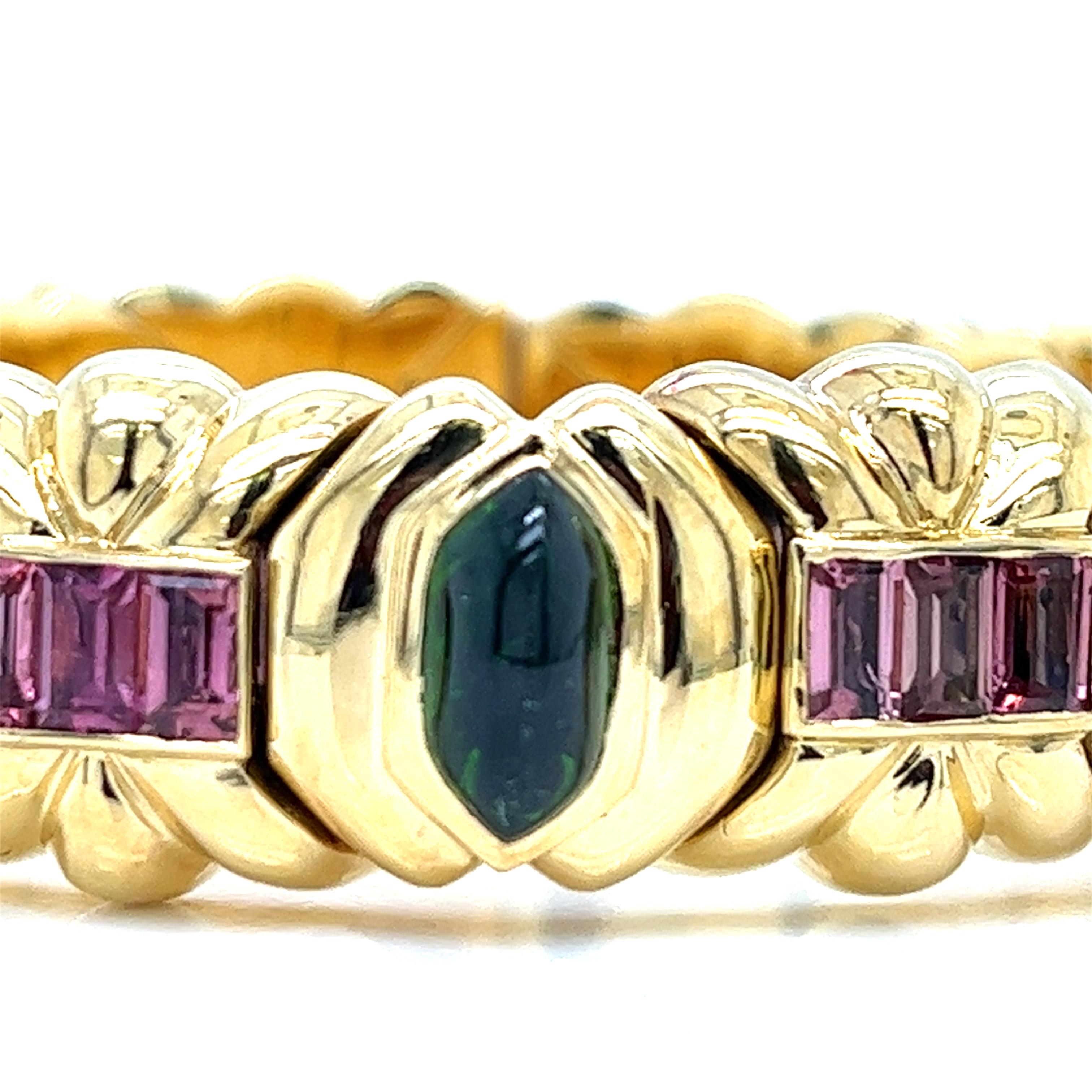 Indulge in the timeless allure of this exquisite Italian bangle bracelet, a testament to 1980s sophistication. Crafted with meticulous attention to detail, it boasts three mesmerizing hexagon-cut green tourmalines, each a verdant oasis amidst the