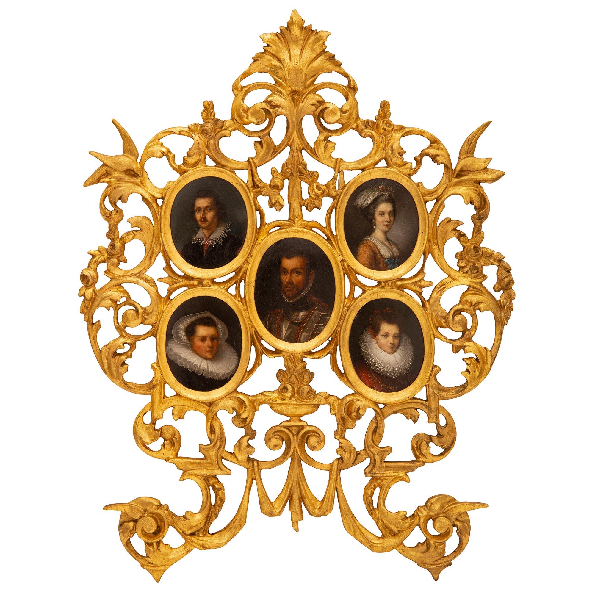 A remarkable and most unique Italian 18th century Baroque st. giltwood and oil on board picture frame/painting of the Louis Philippe family. The picture frame displays a beautiful pierced giltwood frame with richly carved and extremely decorative