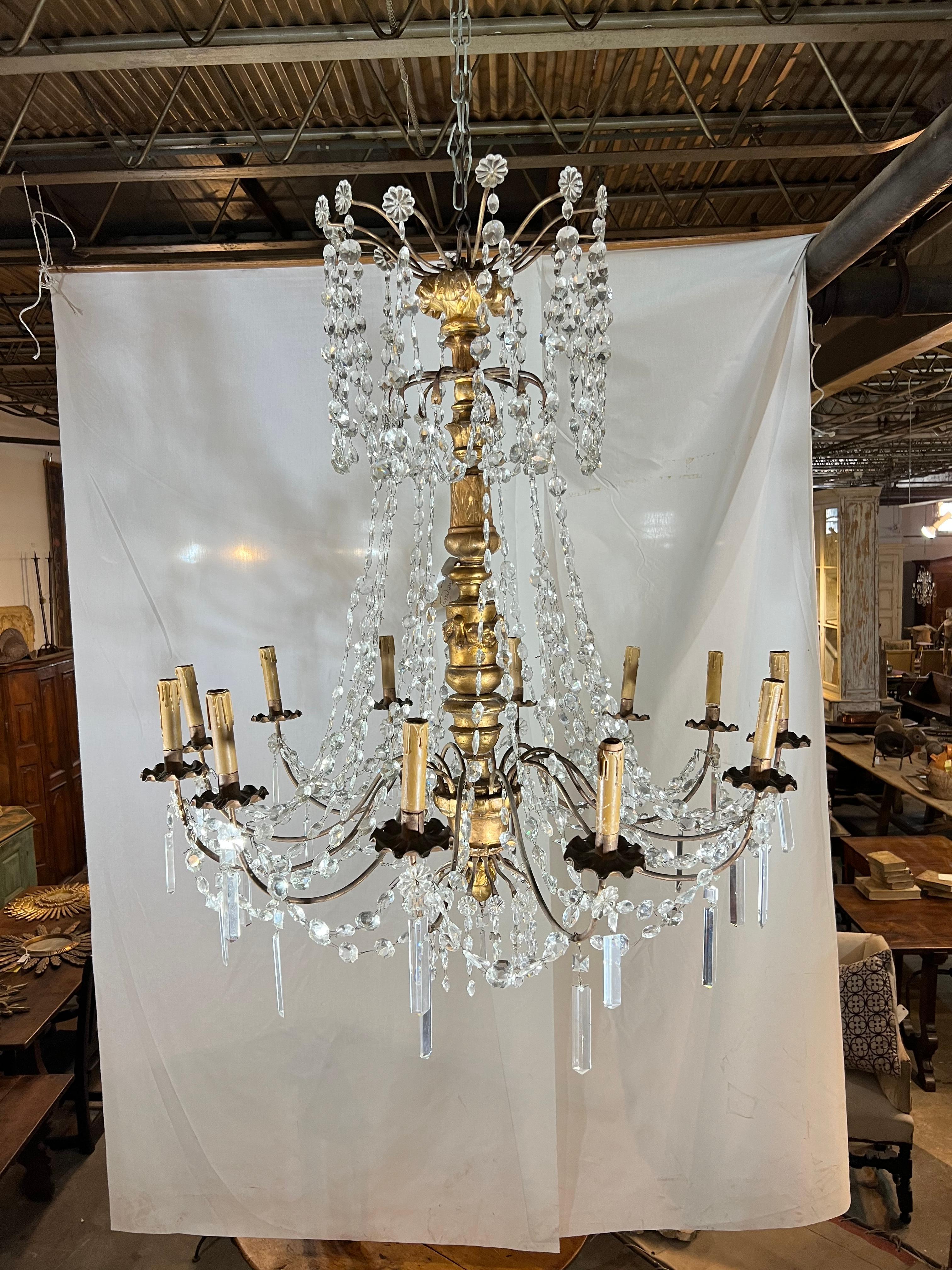 A stunning 18th century Chandelier from the Genoa region of Italy.  Beautifully crafted in giltwood and crystal with 12 lights.  The statement of its surrounding.  