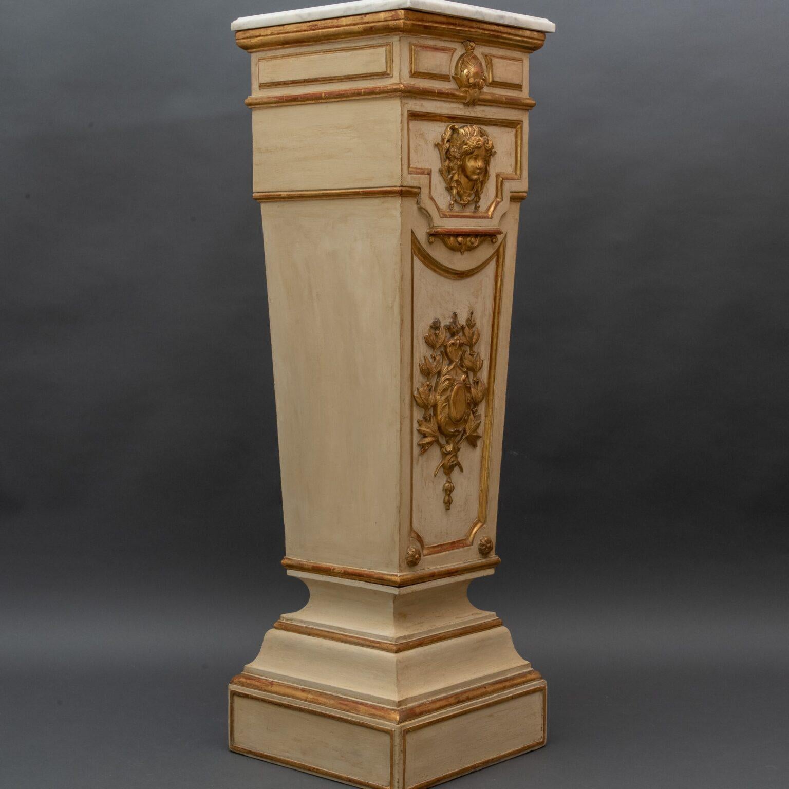 Column in lacquered and gilded wood

Trapezoidal column in lacquered wood with ivory and gold finish.

Adorned with relief frames. A face of a woman in carved, gilded wood embellishes the front.

The top is white marble

Italy, late 18th