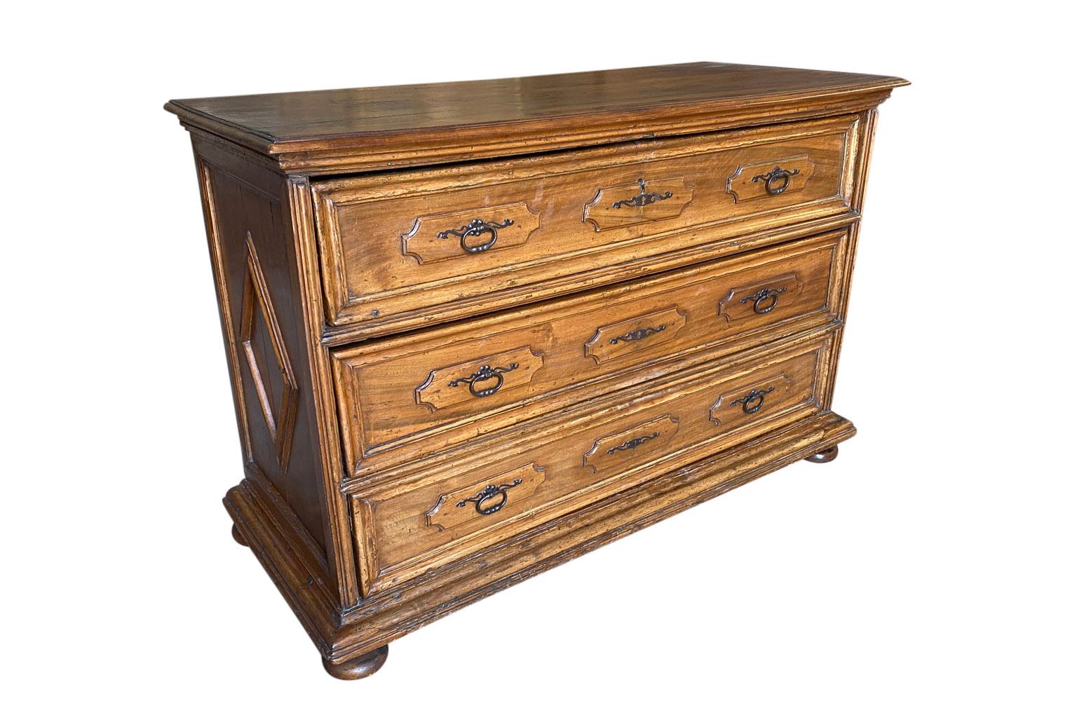 A very beautiful 18th century commode from the Lombardi region of Italy. Soundly constructed from stunning walnut with diamond shape molded side panels raised on bun feet. Excellent patina and graining.