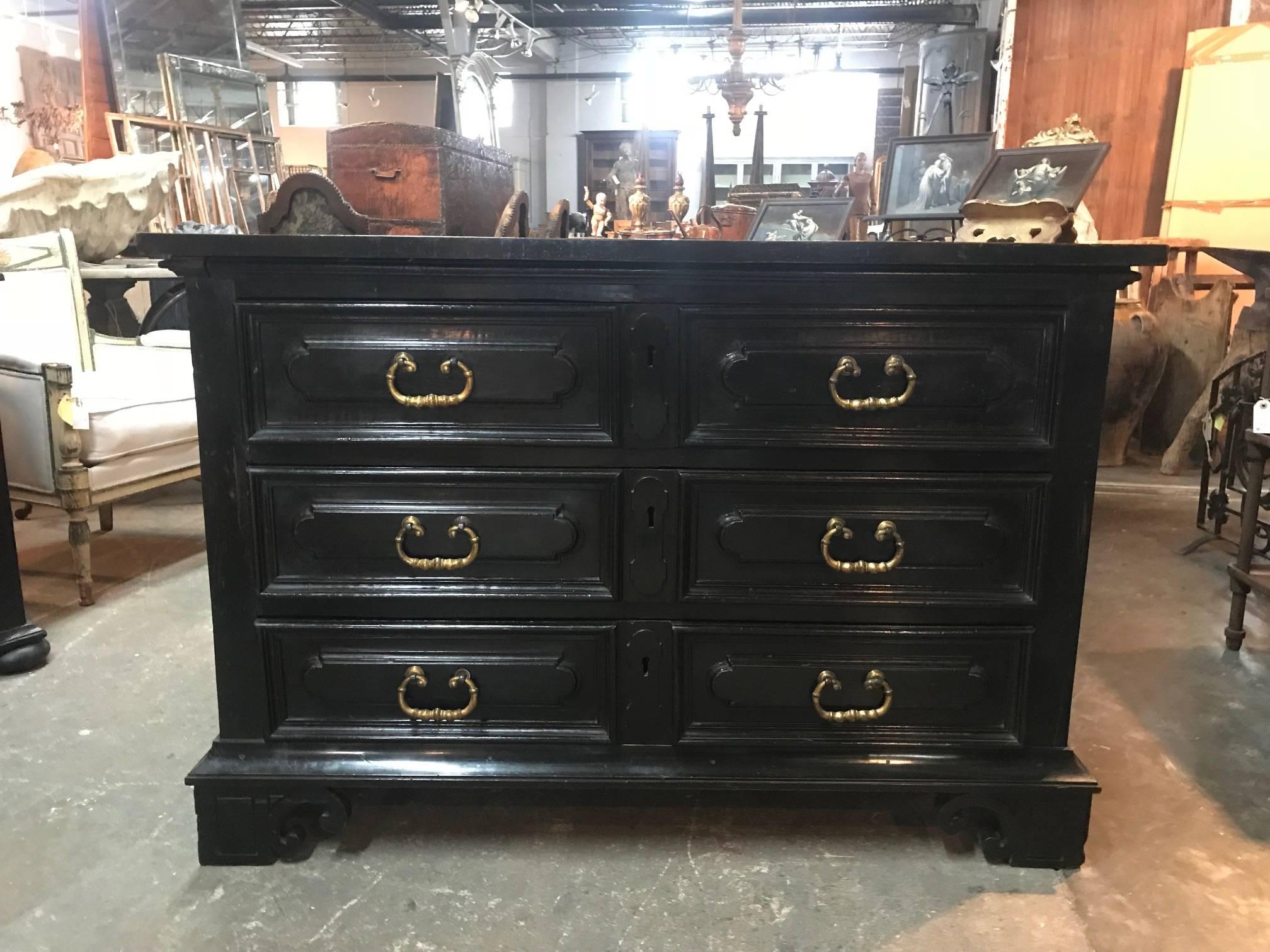 A very striking 18th century commode from the Lombardi region of Italy. Beautifully constructed with its original ebonized finish. Three molded drawer fronts with conforming apron and sculpted bracket feet. The commode has a pull out board for