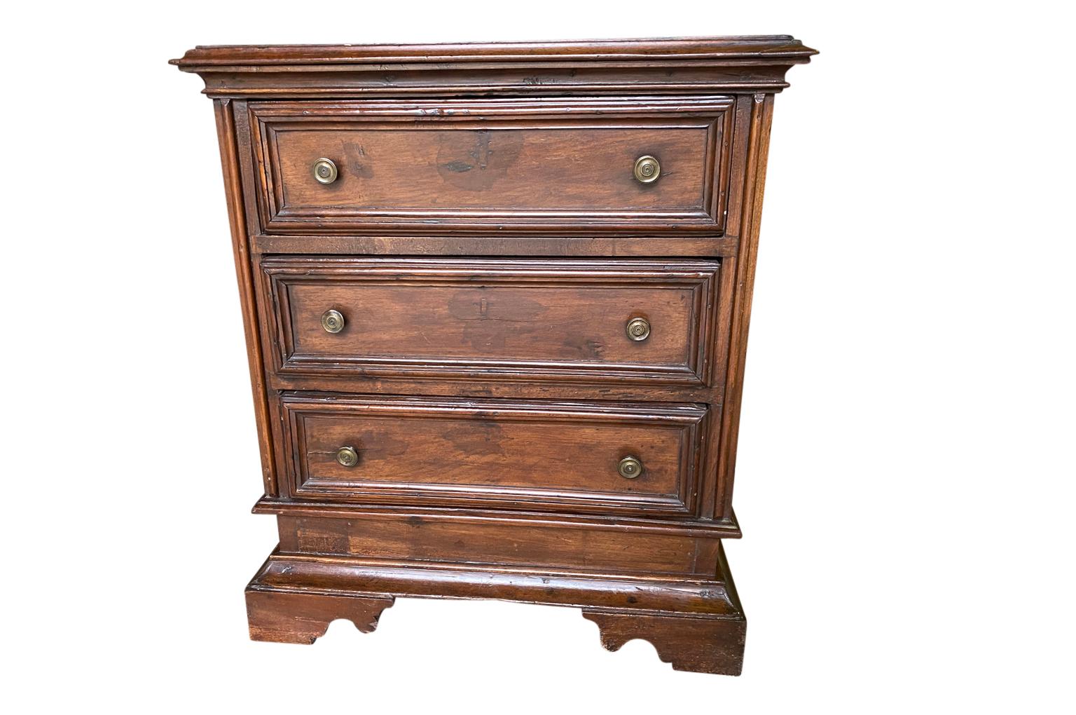 A very handsome 18th century Comodini from the Lombardy region of Italy. Soundly constructed from handsome walnut with a shaped top over three drawers resting on bracket feet.