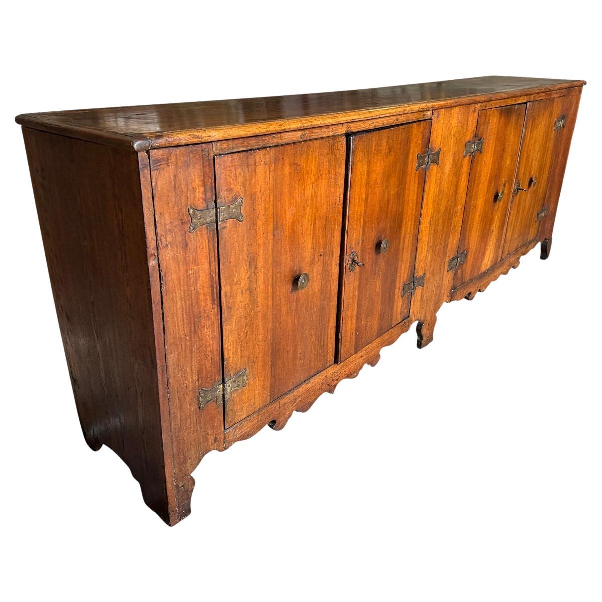 A stunning 18th century Credenza from Tuscan region of Italy. Wonderfully constructed from walnut with 2 sets of doors and a beautiful sculpted apron. Outstanding patina - warm and luminous. 