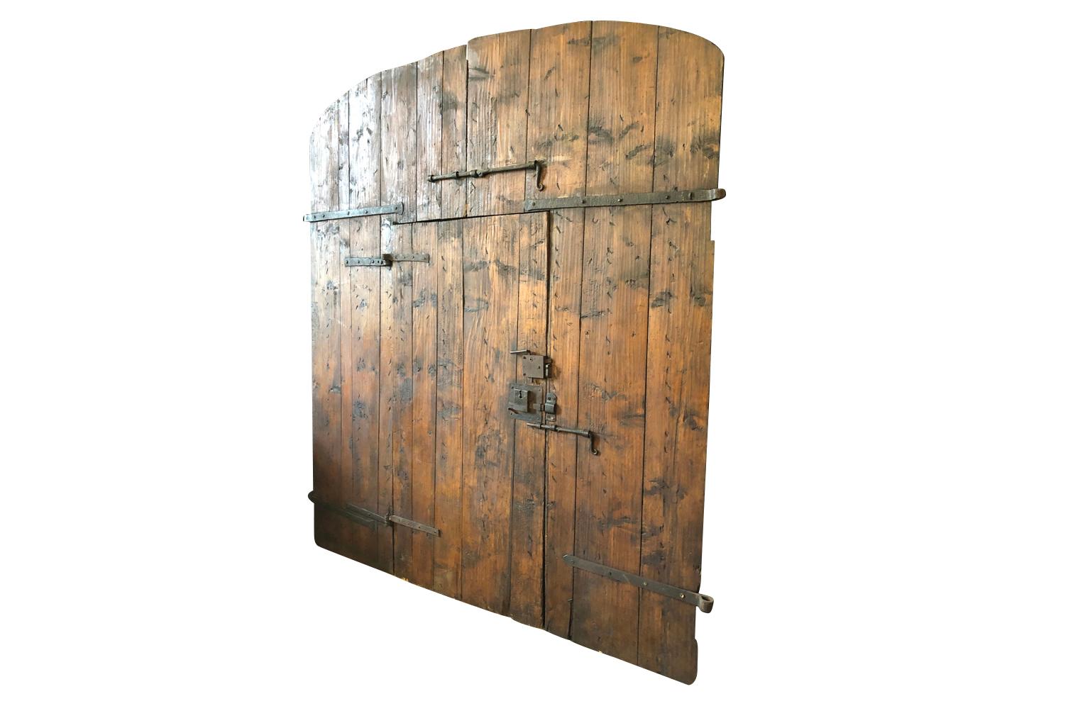 Tremendous 18th century entry doors from the Tuscan region of Italy. Soundly constructed from hard pine with excellent iron fittings. Beautiful from both sides. Great patina.