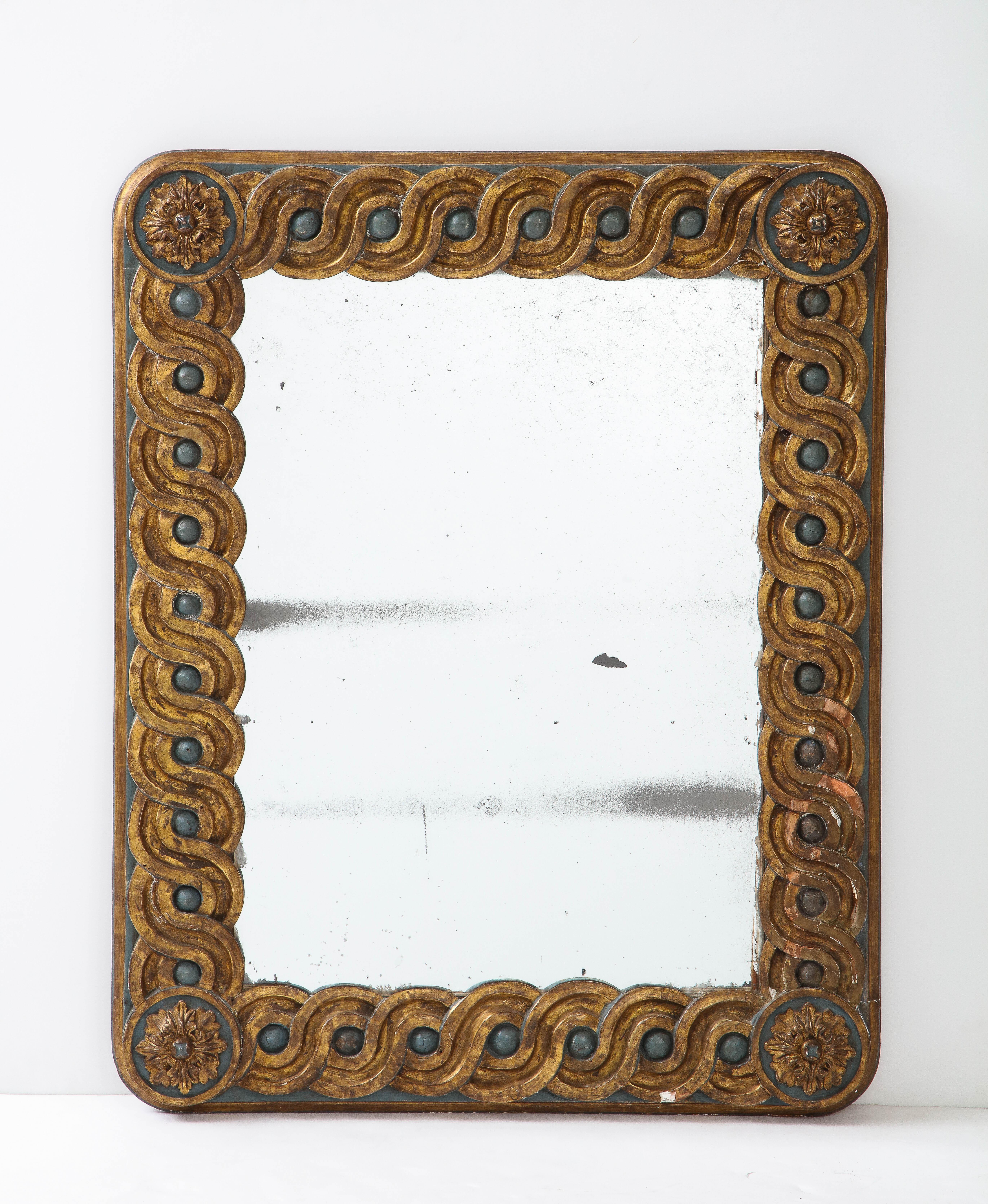 An Italian carved and painted gilded wood mirror, the whole with guilloche gilded carving and large painted bead motif within. The background of the frame is painted in a beautiful blue/green or teal, the frame with rounded corners, each decorated
