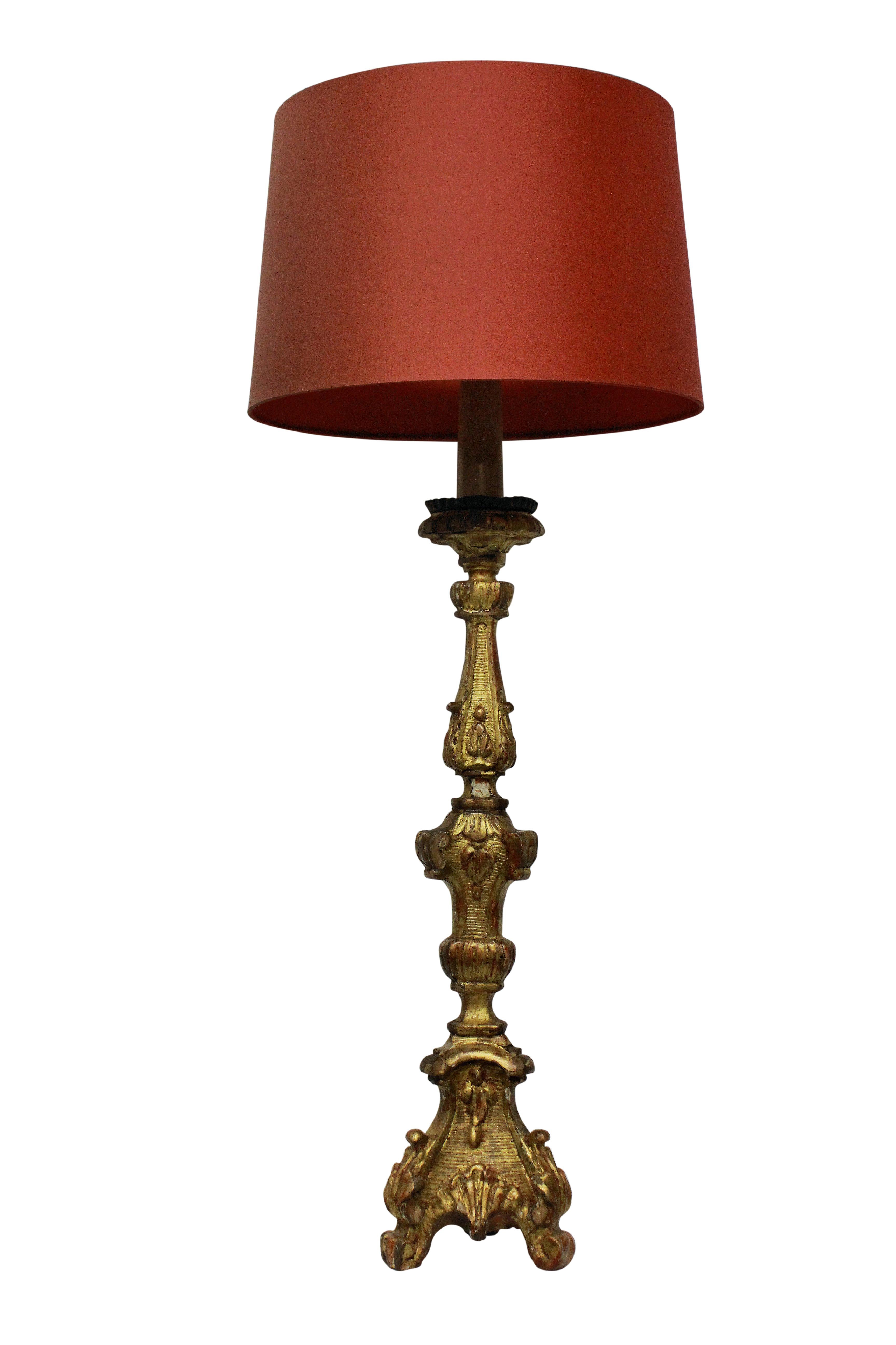 An Italian carved and water gilded Baroque candlestick now converted into a lamp.