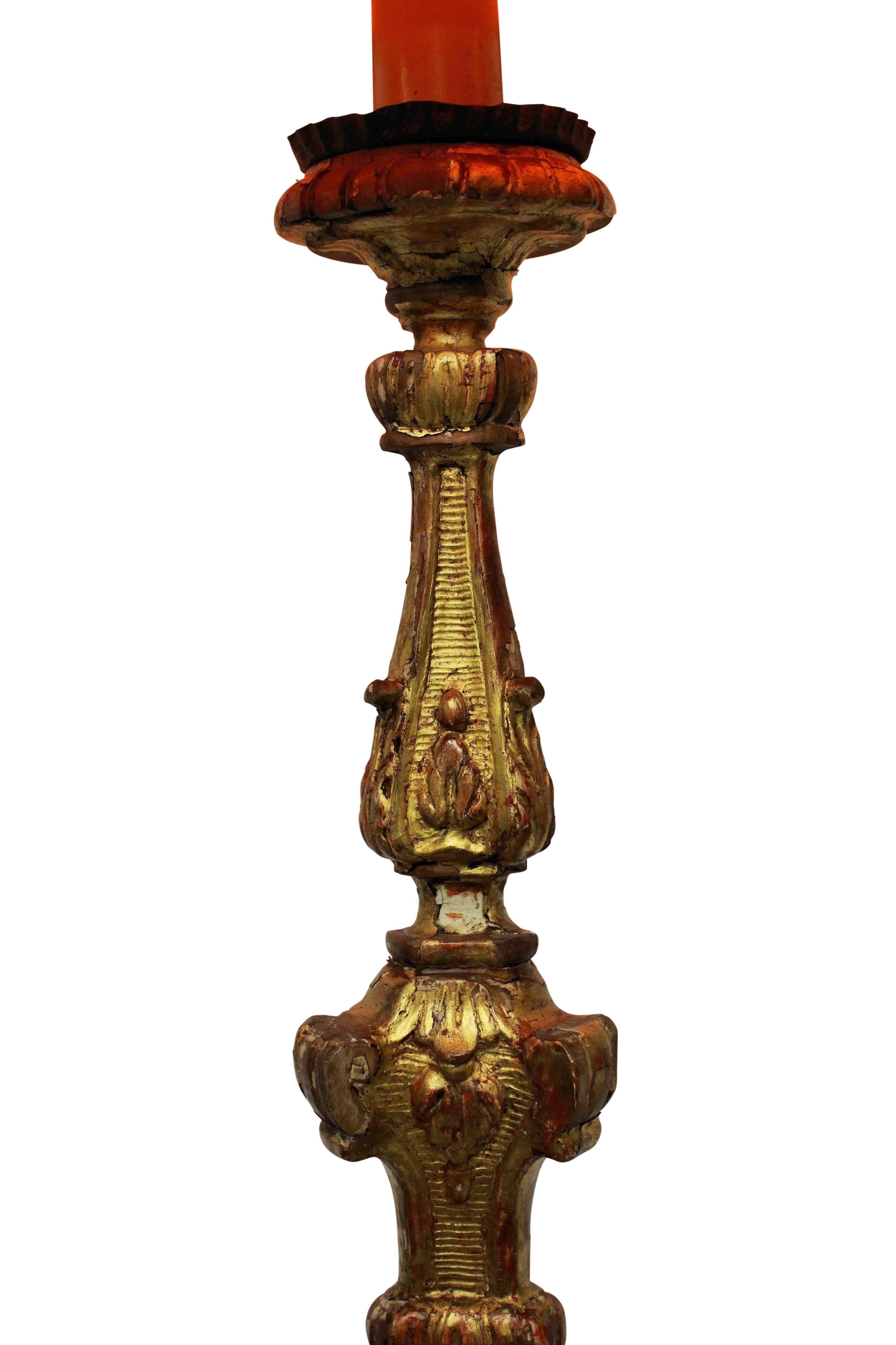 An Italian carved and water gilded Baroque candlestick now converted into a lamp.
