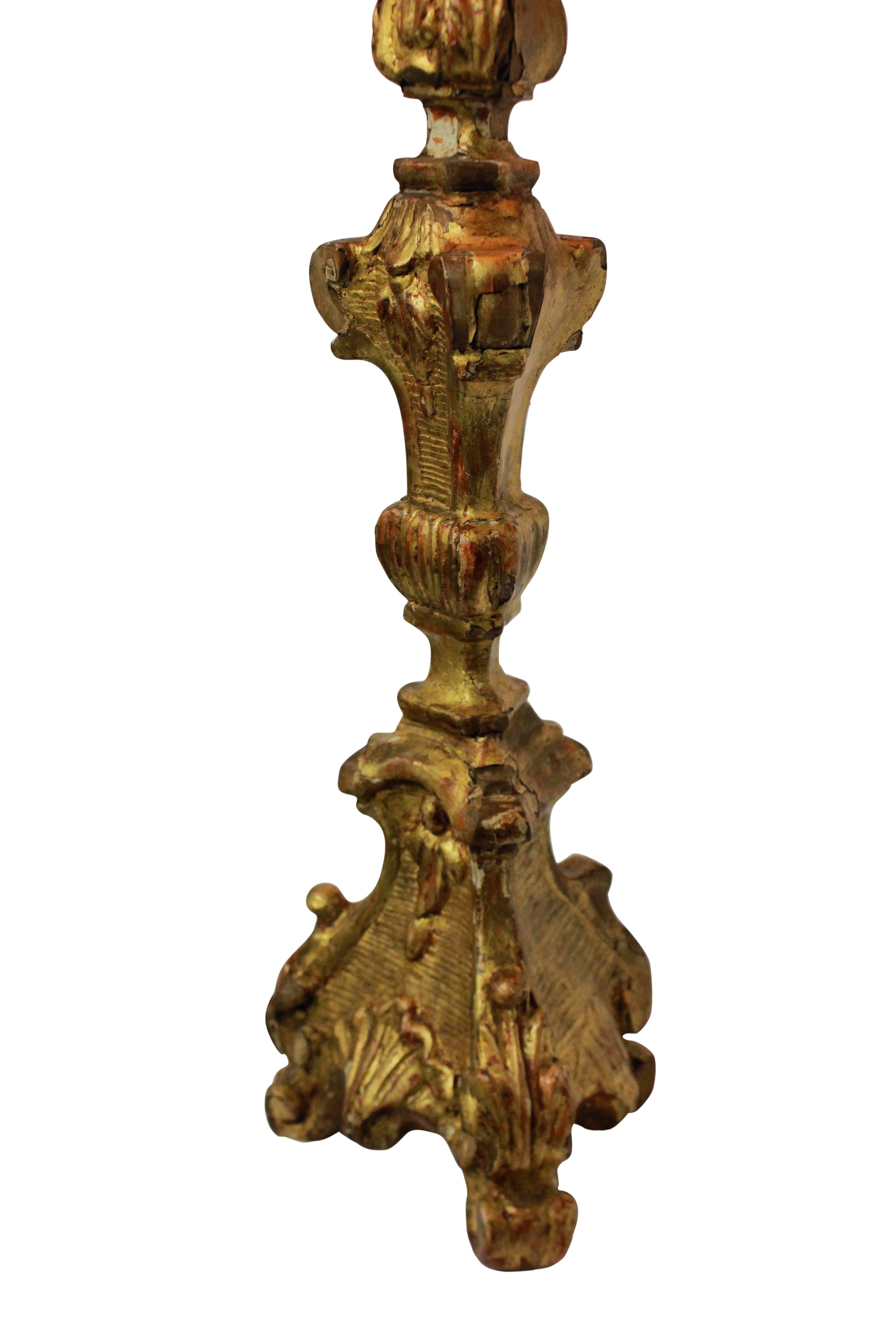 An Italian carved and water gilded Baroque candlestick now converted into a lamp.