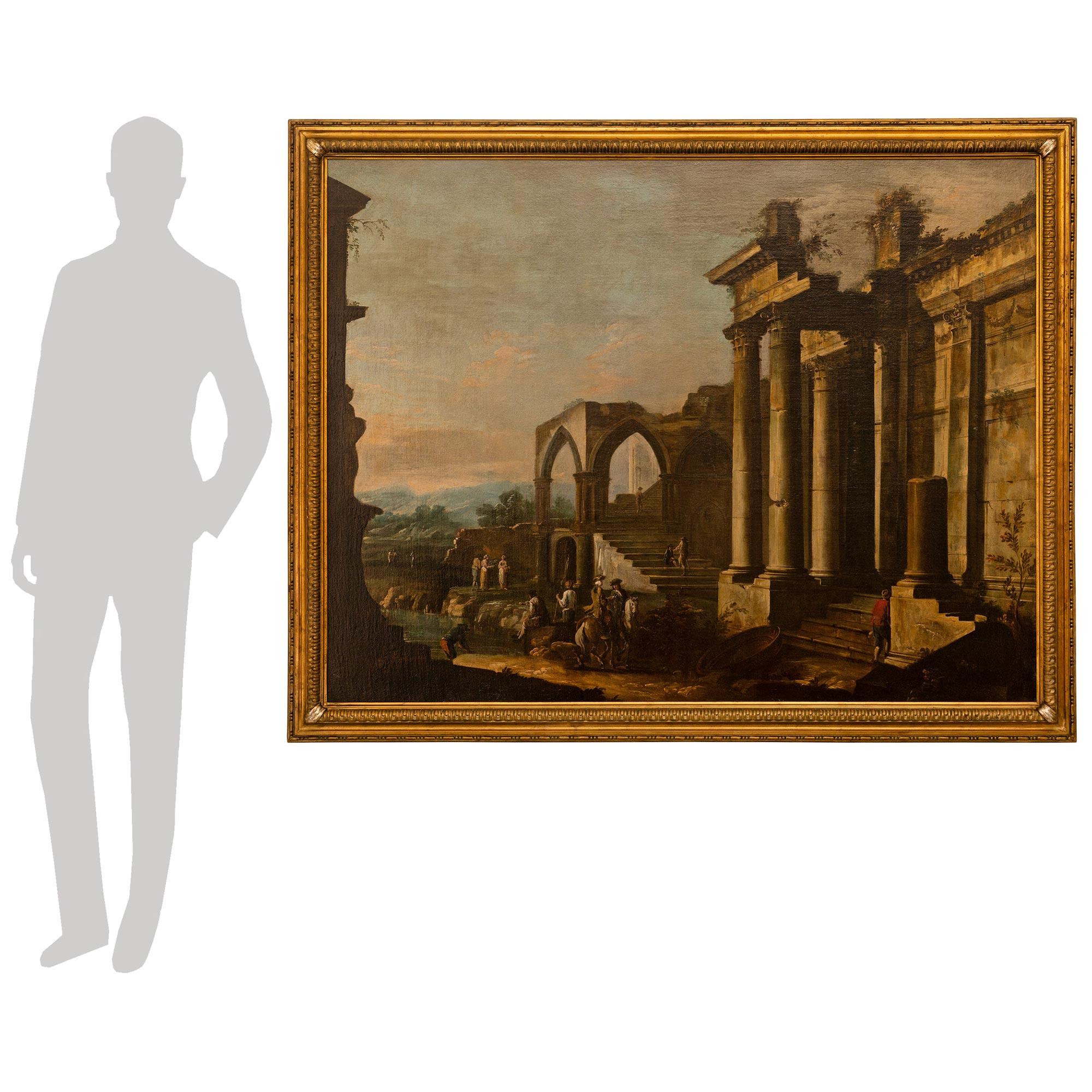 Un cuadro italiano del siglo XVIII, de madera dorada, La Meca y óleo sobre lienzo, muy hermoso y finamente detallado, de Antonio Visentini. Este hermoso cuadro representa unas ruinas italianas con lo que parecen ser campesinos supervisados por