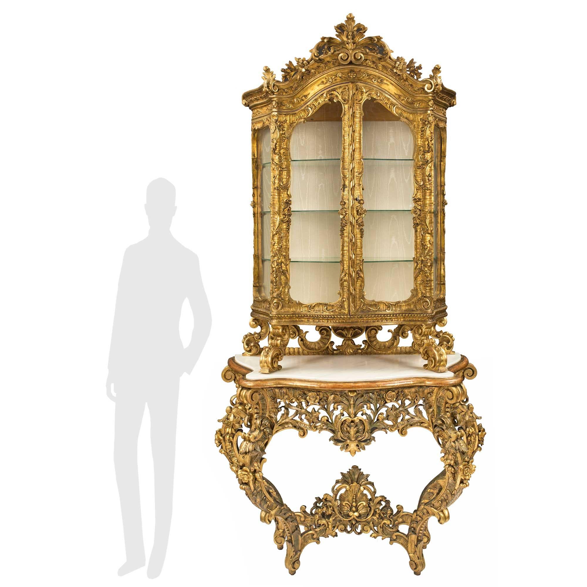 A magnificent Italian 18th century giltwood, polychrome and white Carrara marble Baroque console vitrine from the Piedmont region. This unique and extremely decorative console is raised by stunning cabriole legs with richly carved lavish scrolled