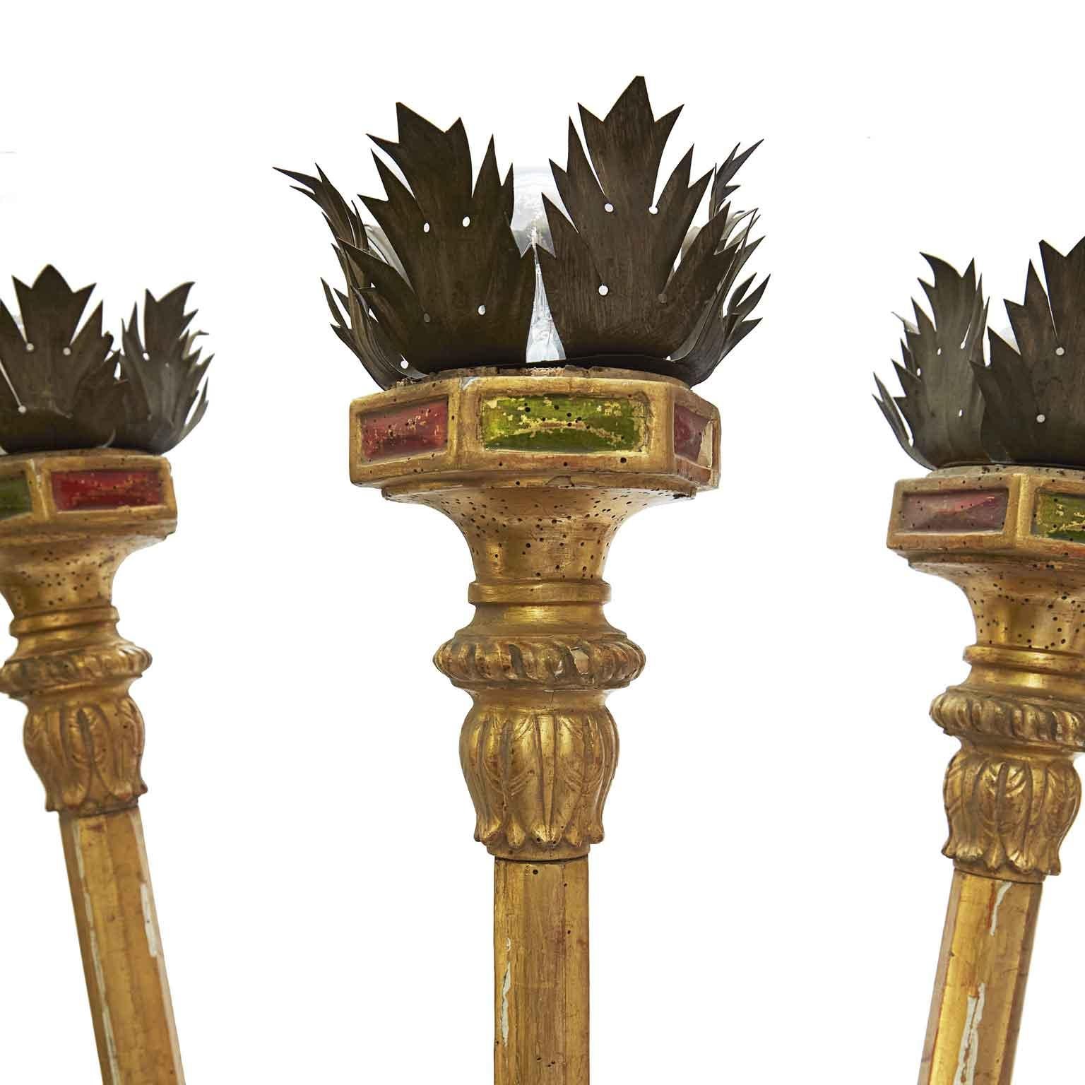 An exceedingly rare and impressive Louis XVI period Italian three-light sconce realized with three red processional pricket torches, more than eight foot tall.

Red Procession Sticks have octagonal section, are joined together by a central pin,   to