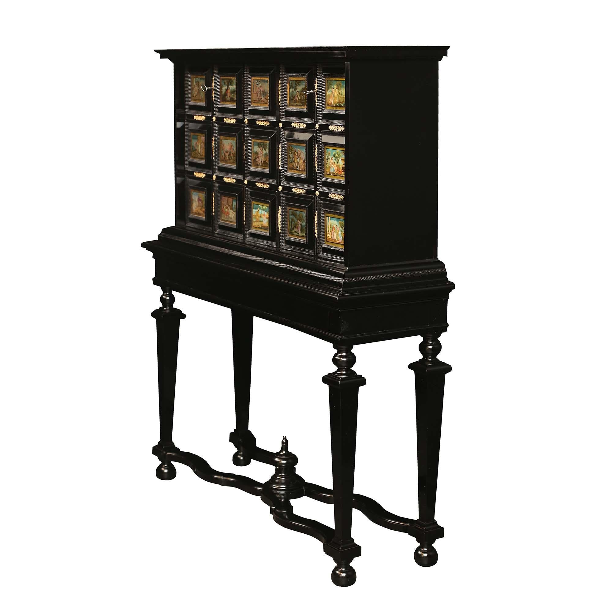 A stunning and high quality Italian 18th century Louis XIV Period ebony and reverse painted glass cabinet on stand. The cabinet is raised on the original stand with four square tapered legs with bun feet, and an X-stretcher with a central topie