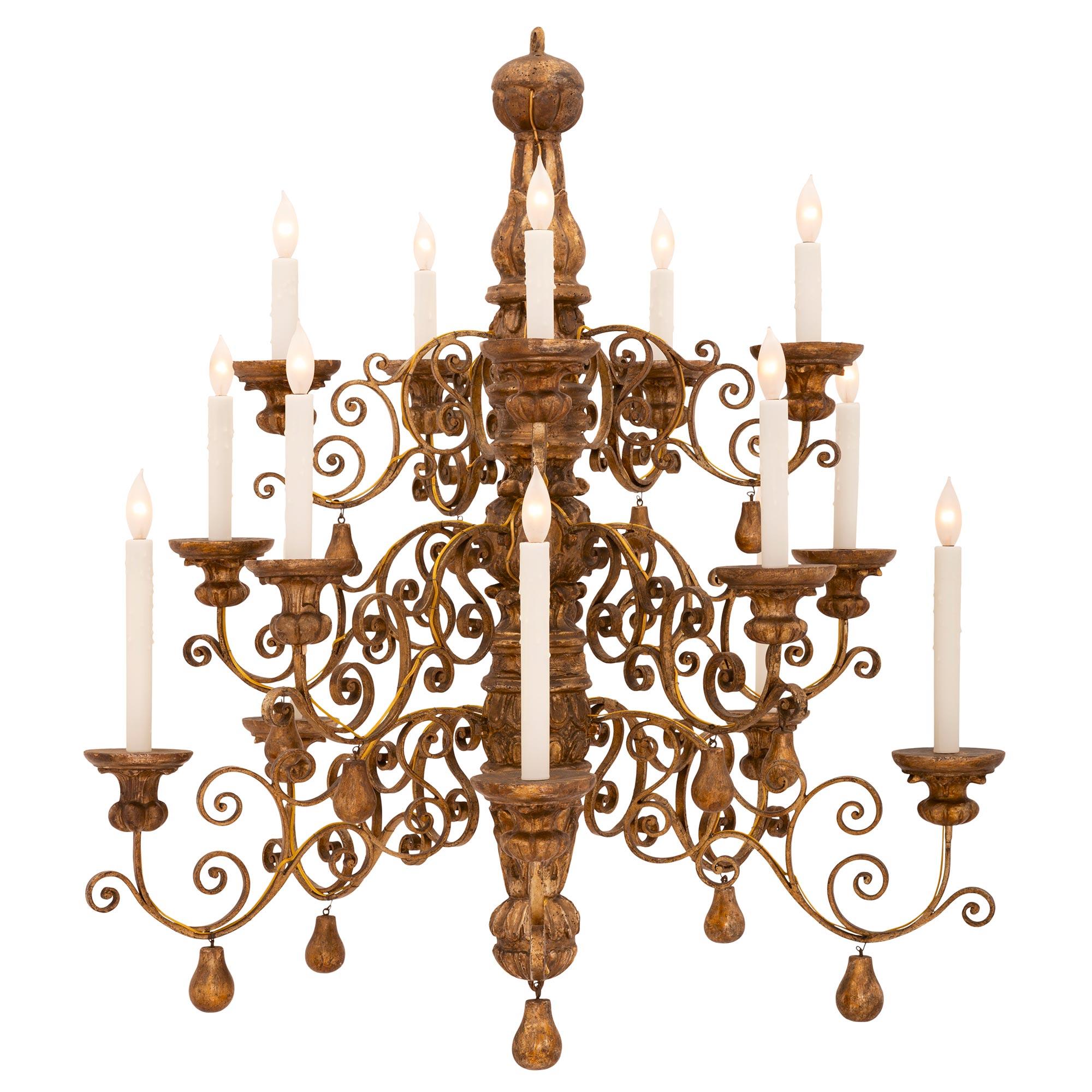 A unique and extremely decorative Italian 18th century Louis XIV period mecca and gilt metal chandelier. The fifteen arm chandelier is centered by a fine carved pear shaped bottom finial also repeated at each of the wonderfully scrolled arms. The