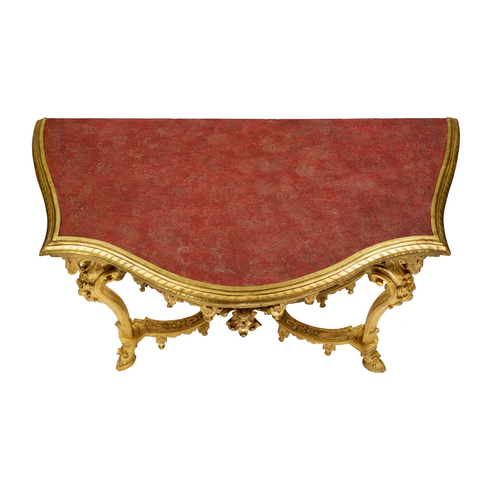 A very impressive and high quality Italian 18th century Louis XIV period Venetian giltwood console. This free standing console is raised on four handsome S scrolled legs with impressive hoof feet and exquisite floral carvings. The outstanding X