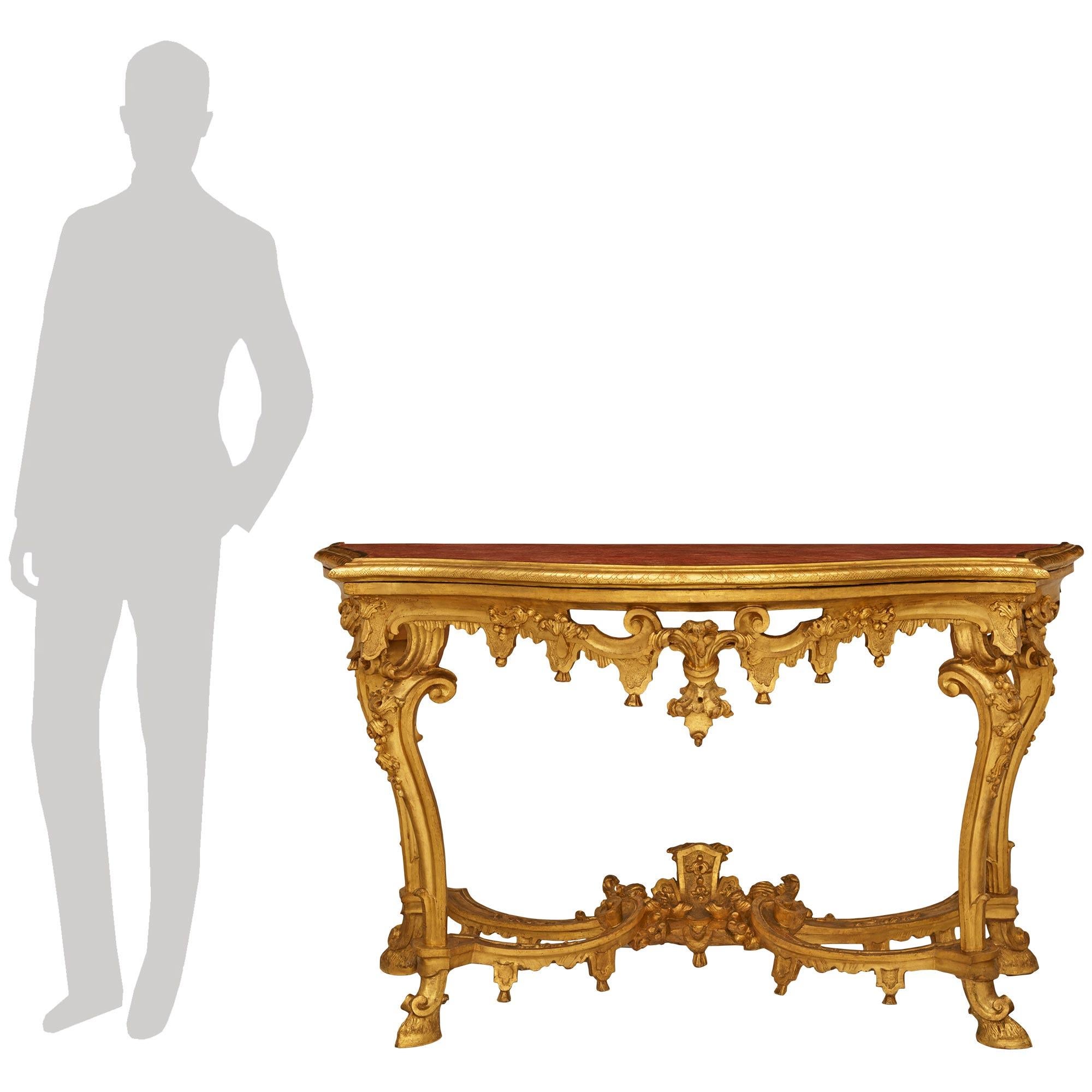 An impressive and high quality Italian 18th century Louis XIV Period Venetian st. Giltwood and Polychrome console. This wonderful free standing console is raised on four handsome scrolled legs with hoof feet, and exquisite floral carvings. The legs