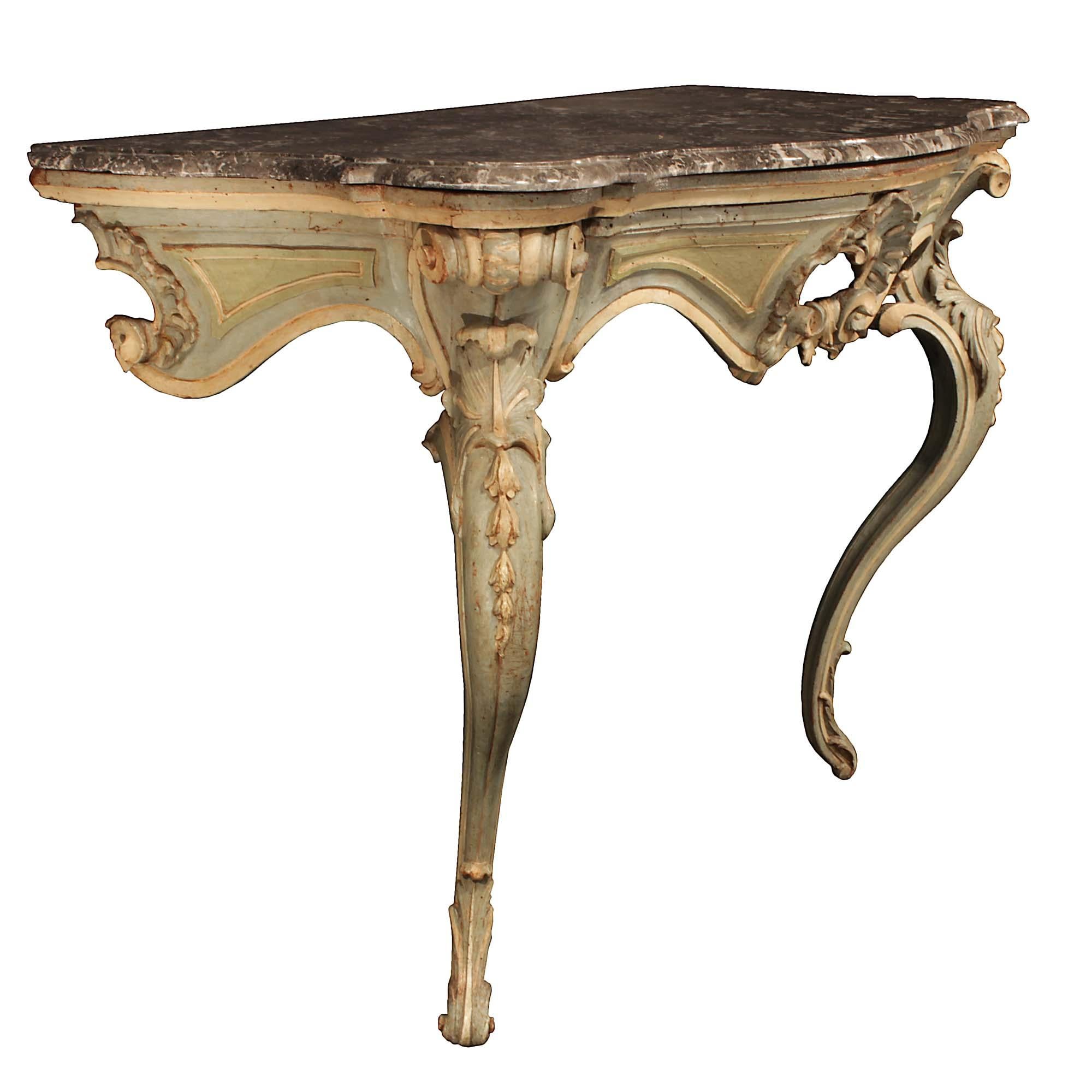 A stunning and extremely decorative Italian 18th century Louis XV period patinated and marble console. The wall mounted console is raised by two slender patinated cabriole legs with carved acanthus leaf accented feet, and larger scrolls at the top.