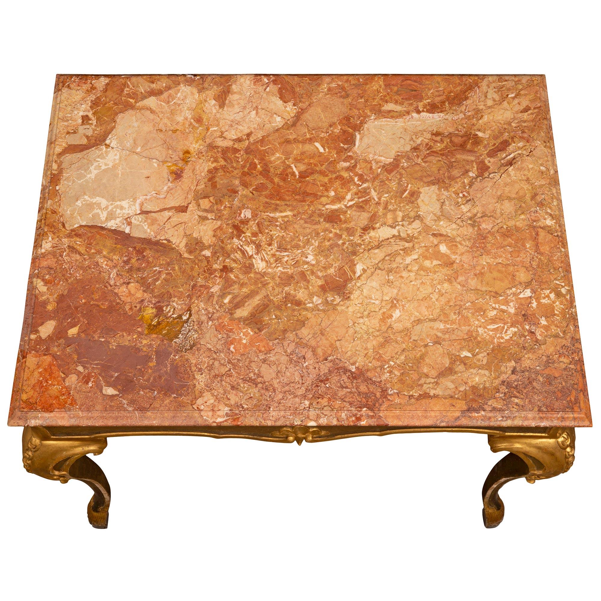 A beautiful Italian 18th century Louis XV period polychrome, giltwood, and Orange Varois marble center table. The rectangular table from Bologna is raised by most elegant polychrome cabriole legs with handsome hoof feet and richly carved giltwood