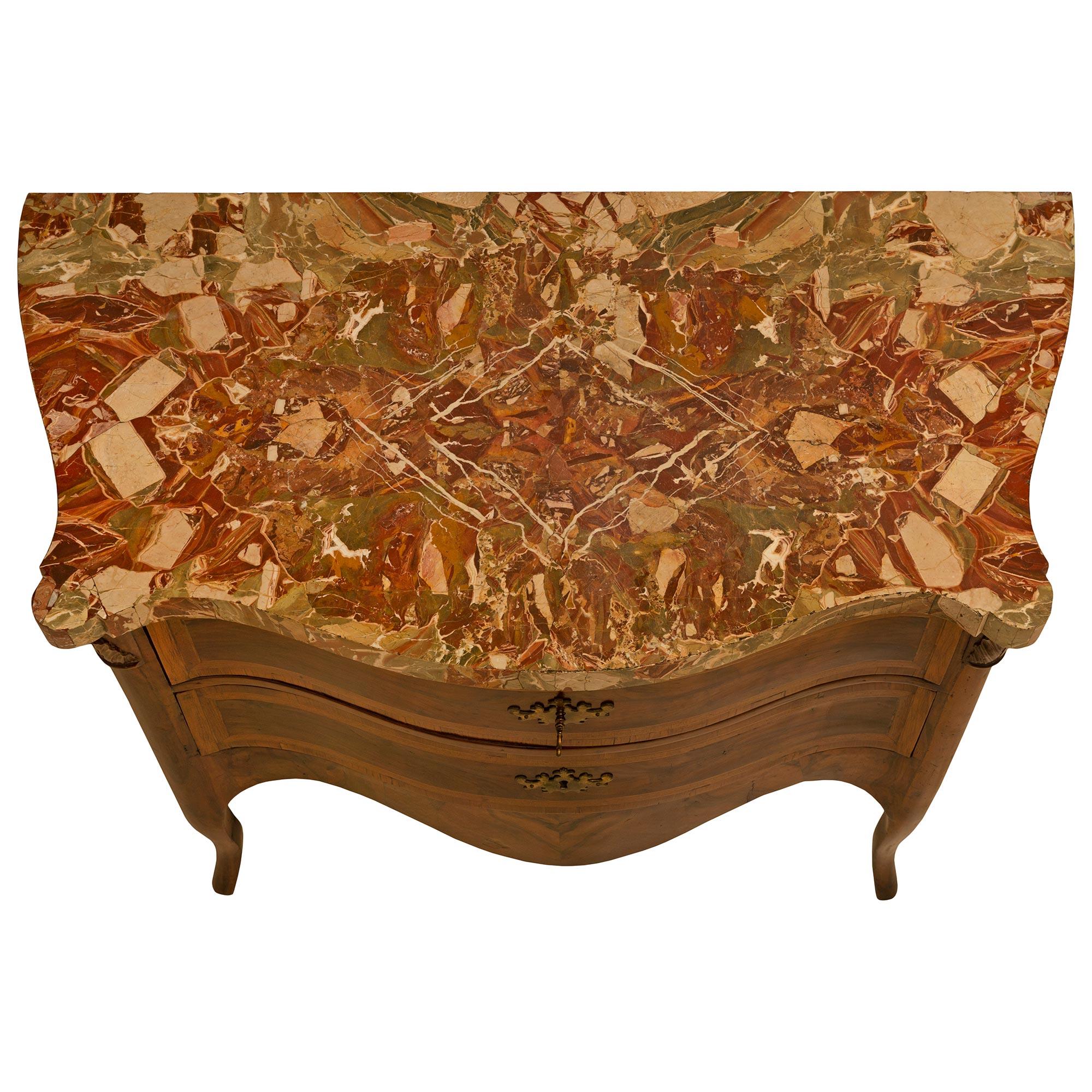 An extremely handsome Italian 18th century Louis XV period two-drawer walnut bombée commode from Rome. The chest is raised on four cabriole legs and an arbalest-shaped frieze. Above each leg is rich acanthus leaves carvings. The drawers have brass