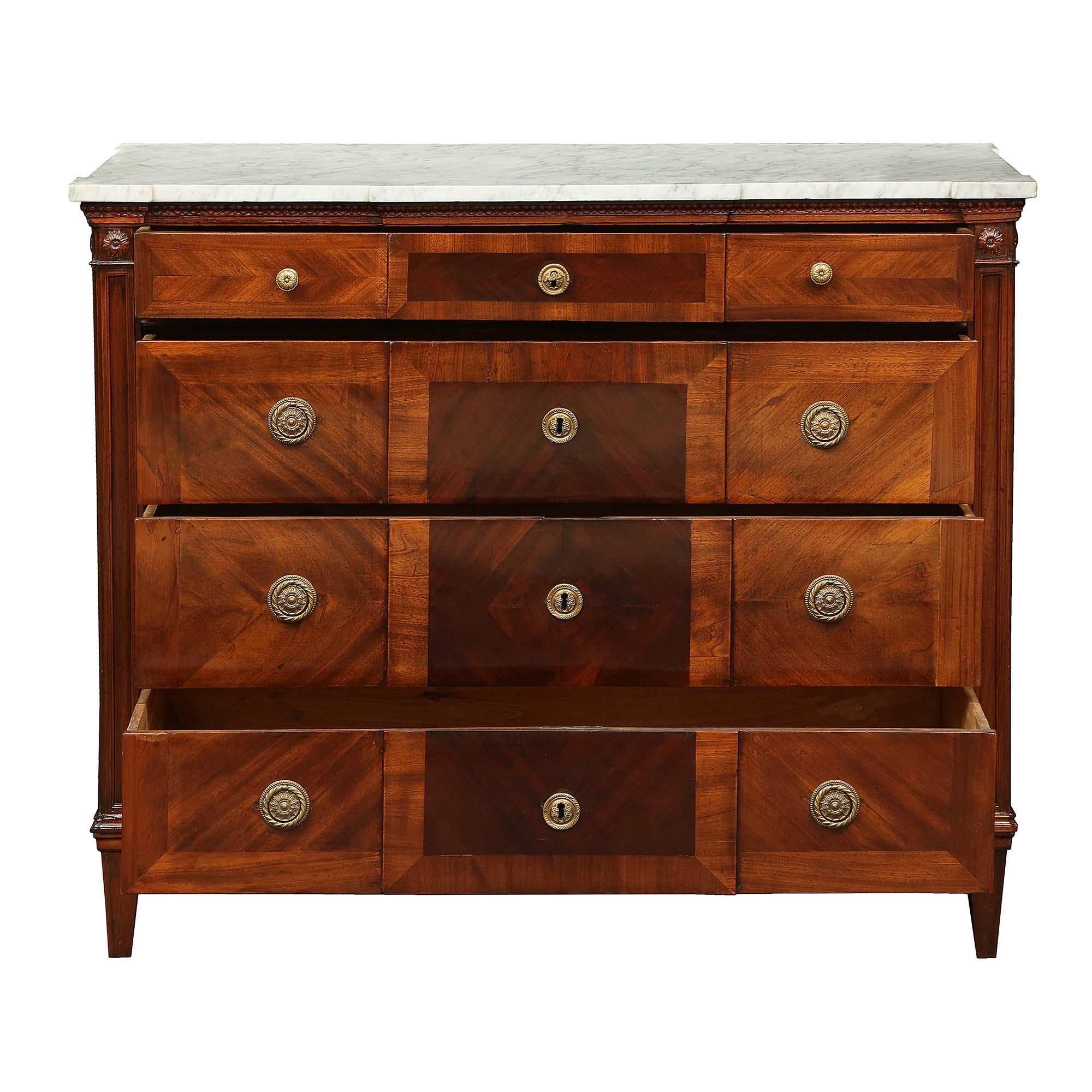A handsome Italian 18th century Louis XVI period four drawer walnut chest. The chest is raised by square tapered legs below the straight frieze. At the center are three drawers, Sans Traverse, and one top drawer. Each drawer displays a dark walnut