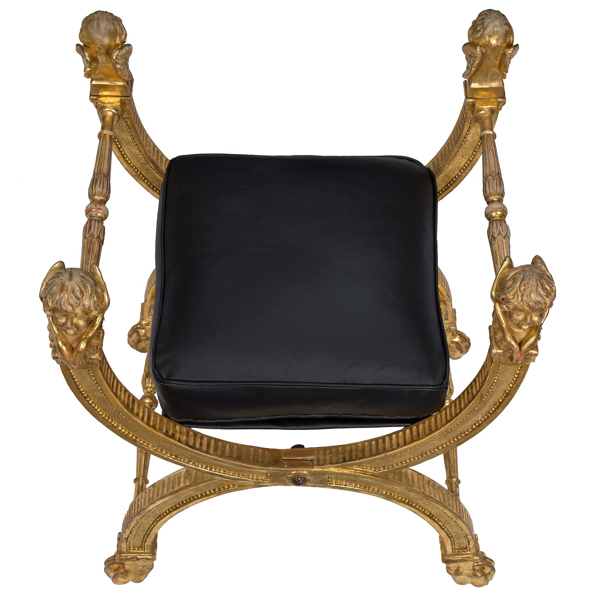 A striking and large scale Italian 18th century Louis XVI period giltwood bench. The bench is raised by handsome paw feet below most attractive X shaped supports. The supports are connected by a carved turned foliate fluted stretcher and display a