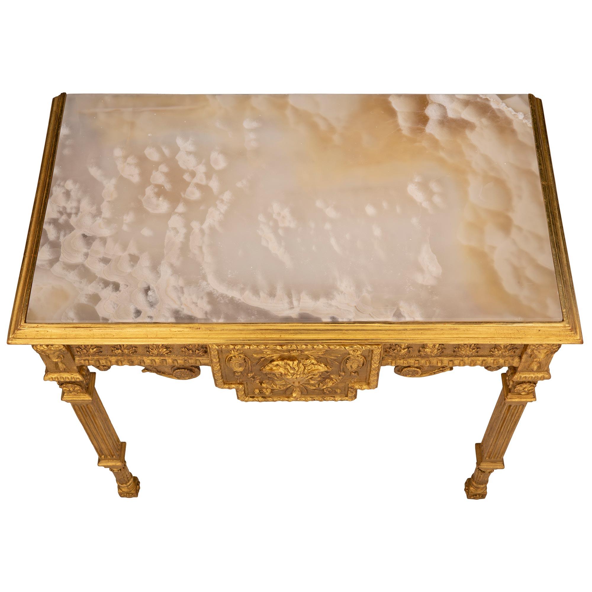 A beautiful and high quality Italian 18th century Louis XVI st. giltwood and Alabastro Cotognino console. The freestanding console is raised by unique and extremely decorative block rosette feet below baluster shaped acanthus leaf carvings and