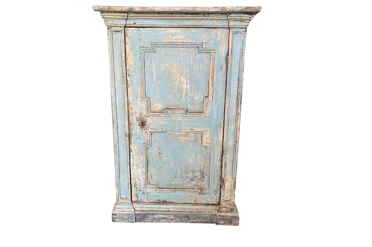 A very charming 18th century cabinet - Cupboard from the Tuscany region of Italy. Beautifully constructed from painted wood with a single door, interior shelf resting on a plinth base. Wonderful finish and patina.