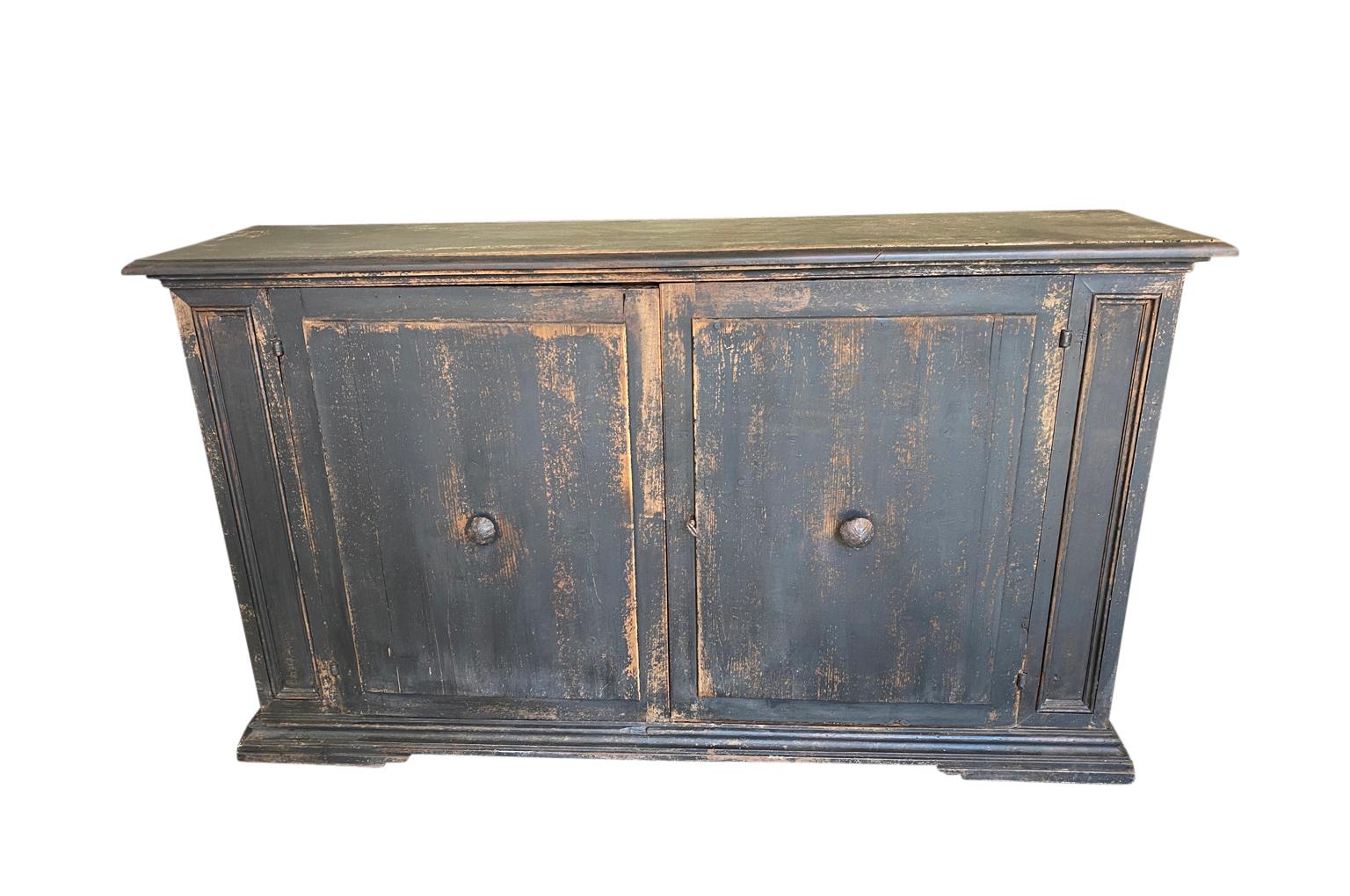 A very handsome 2 door 18th century credenza from Northern Italy. Soundly constructed from painted walnut and pine. Wonderful finish and patina. Excellent narrow depth.