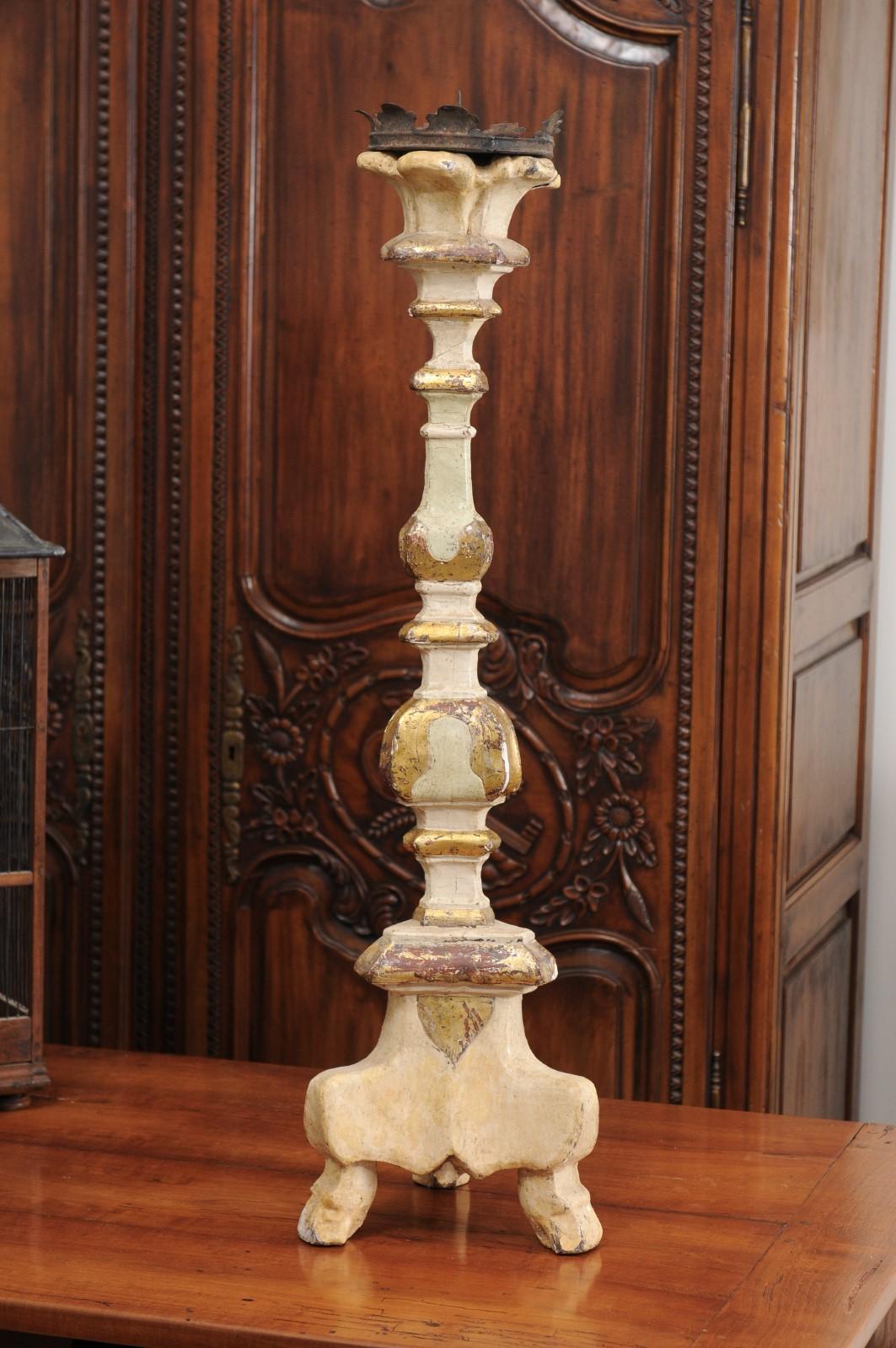 An Italian 18th century painted wood candlestick from Tuscany with touches of gilt. Created in central Italy during the 18th century, this Tuscan candlestick features a painted structure delicately accented with gilt highlights. Topped with a metal
