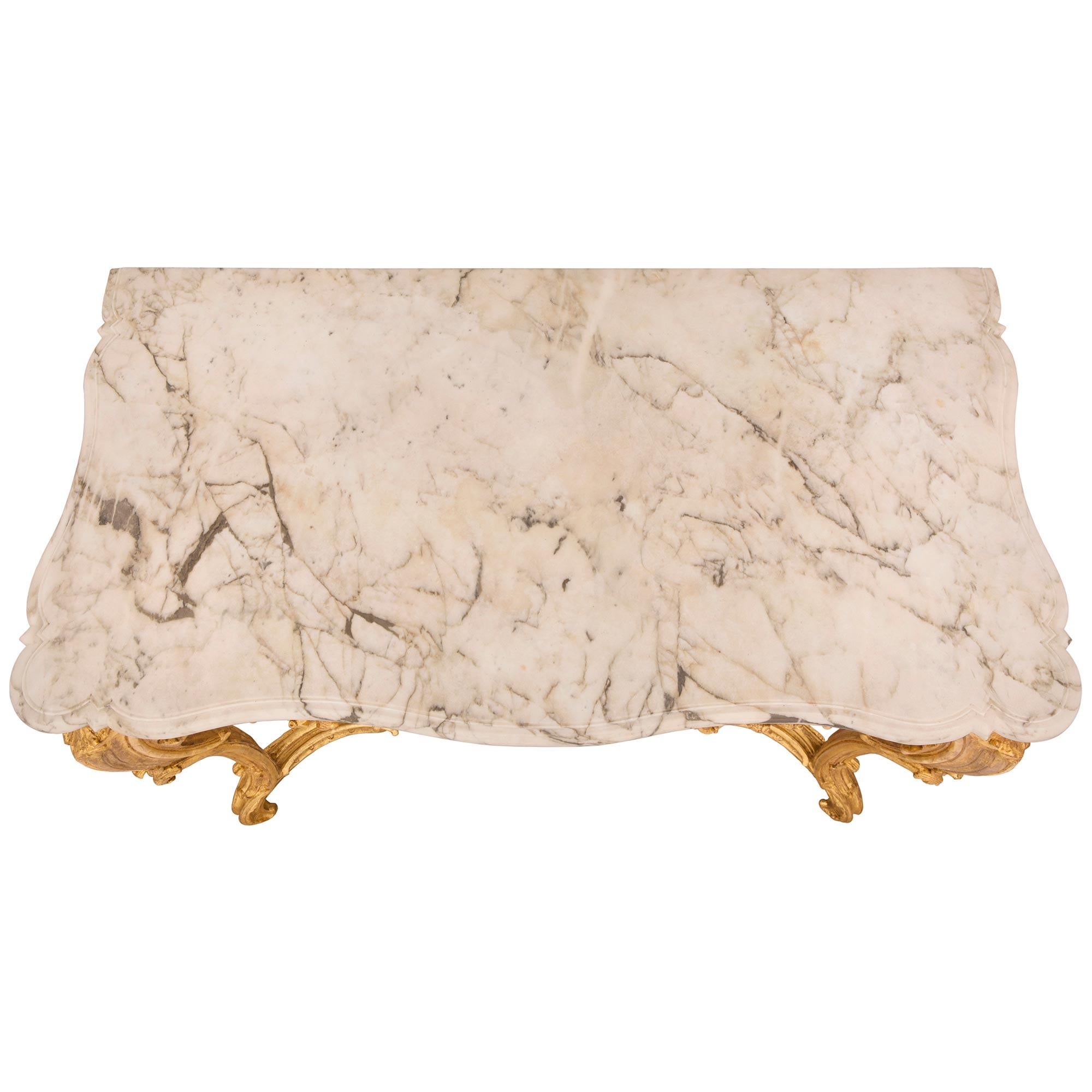 A stunning Italian 18th century Regence st. Louis XV period giltwood and Calacatta marble console. The freestanding console is raised by striking cabriole legs with elegant scrolled foliate feet, large acanthus leaves and beautiful richly carved
