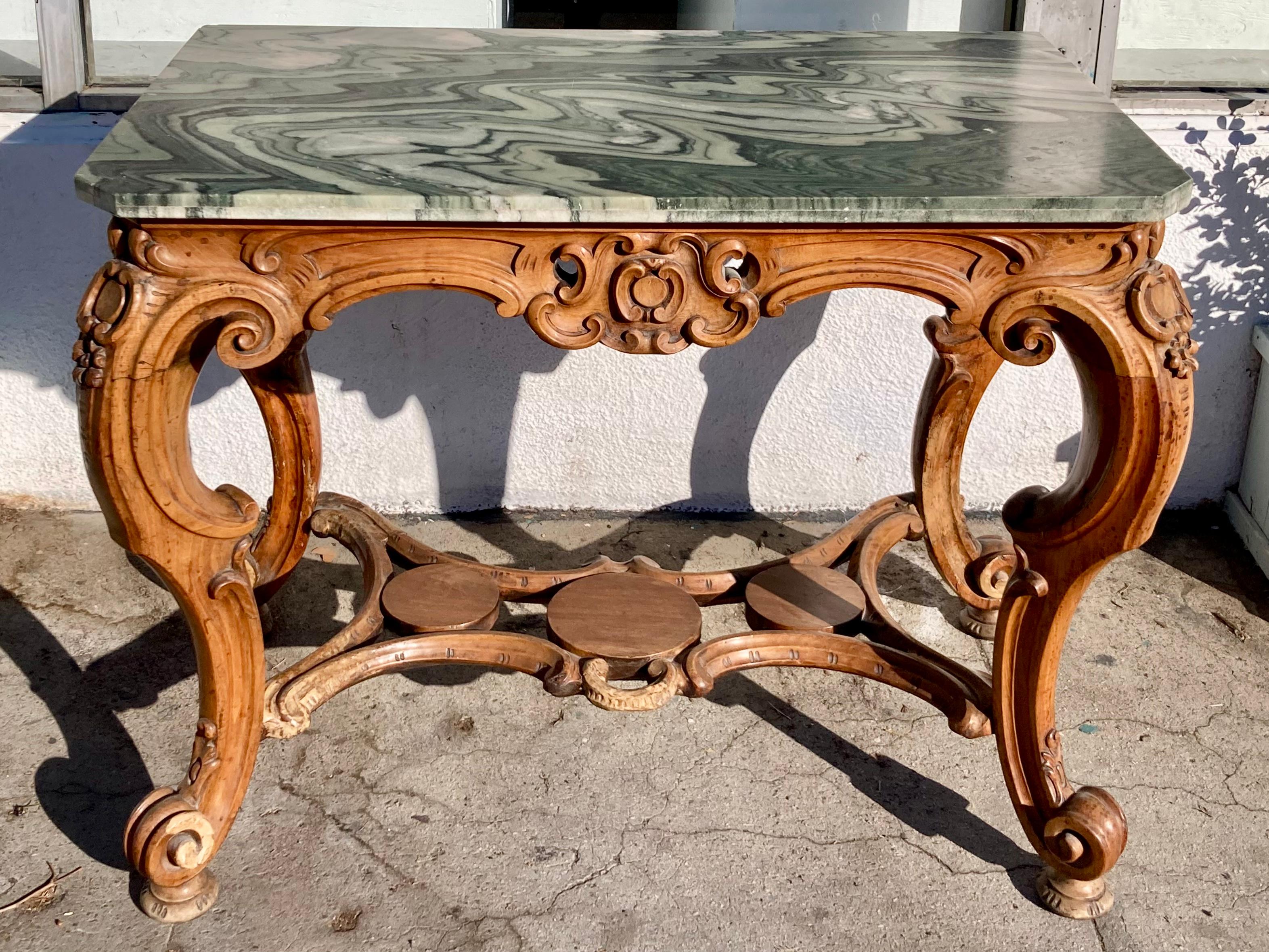 Italian 18th Century Regency carved console with unusual green marble top. Gorgeous carved wood details. Carving on all visible sides . Nice size console with the most beautiful green marble top. Add some classic Italian style to your interiors.