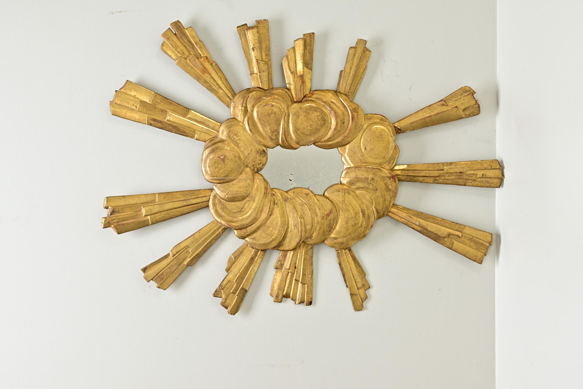 This phenomenal mirror from 18th century Italy retains the same magnetism since its original purpose, likely for an ecclesiastical need, to symbolize the Divine and celestial. Gilded, faceted rays erupt at oblique and random angles from behind a