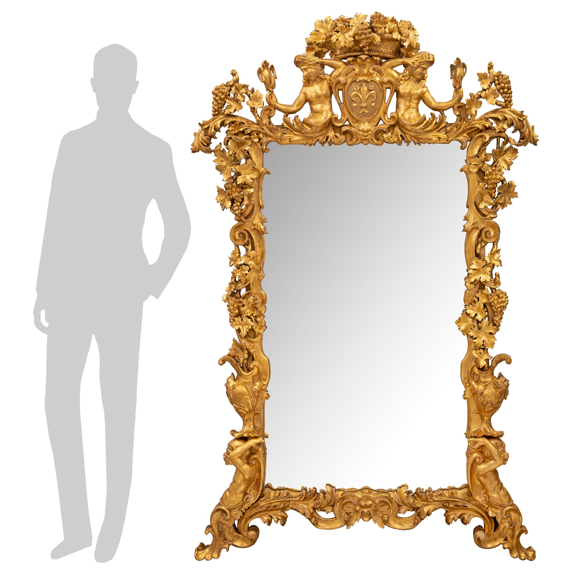 A spectacular and extremely high quality Italian 18th century Rococo period giltwood mirror. The mirror retains its original mirror plate set within the stunning intricately detailed giltwood frame. The frame displays an impressive central mask at