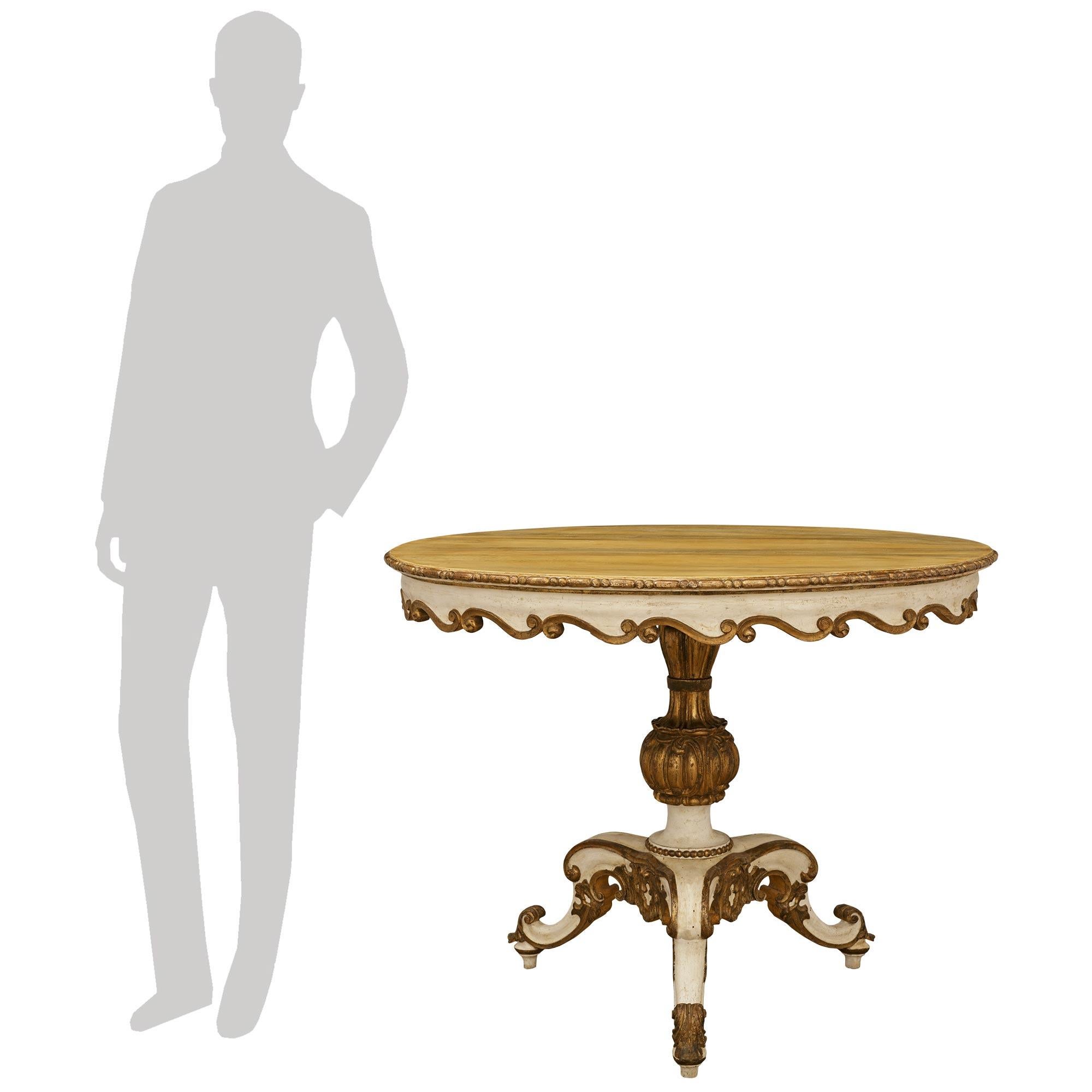 Ein eleganter und sehr dekorativer italienischer Rokokotisch aus dem 18. Polychrome und Mekka Mitte Tisch. Dieser wunderbare ovale Tisch steht auf einem dreibeinigen Sockel mit verschnörkelten Stützen, die mit beeindruckenden Rocaille-Schnitzereien