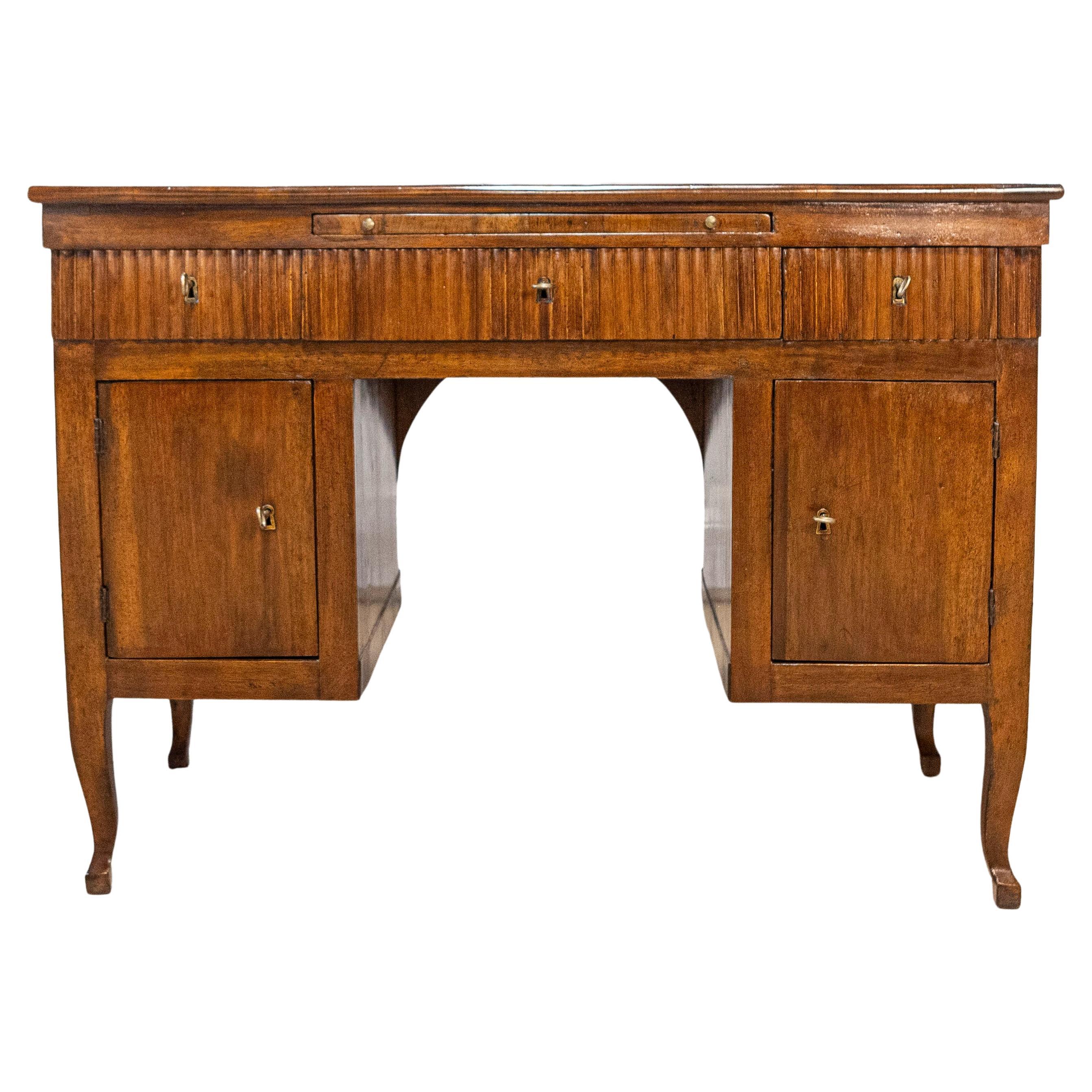 Italian 18th Century Walnut Desk with Carved Reeded Apron, Drawers and Doors For Sale
