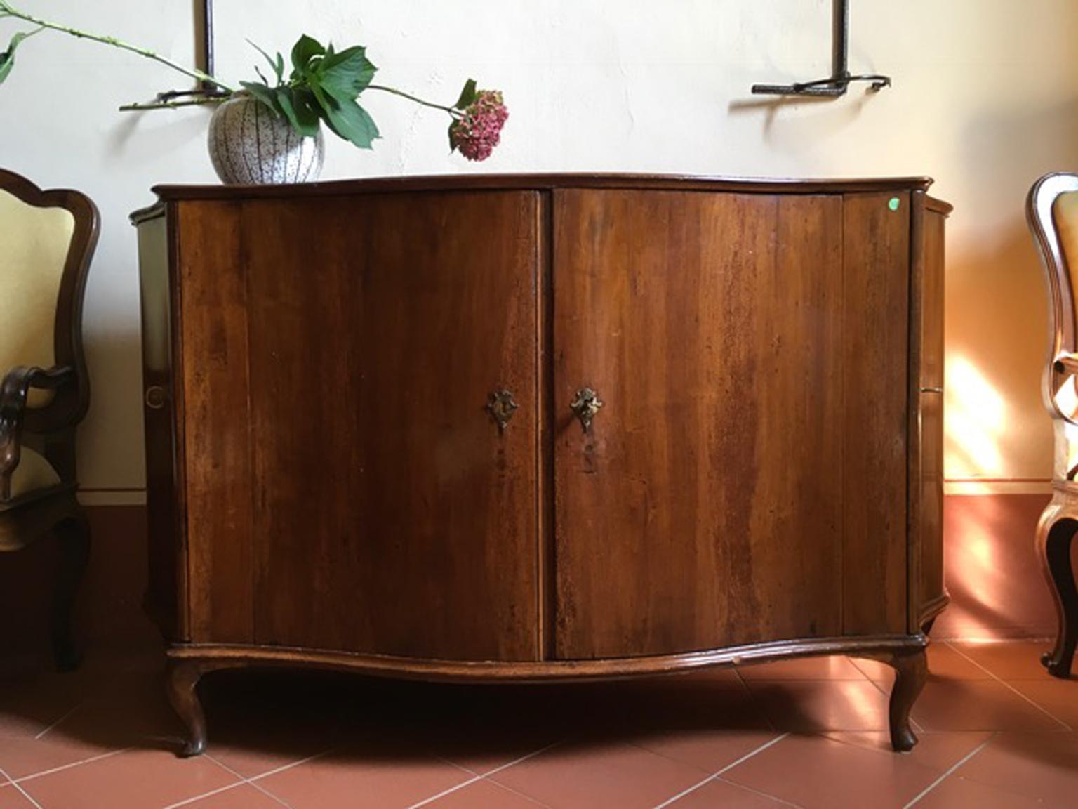 Venice Italy mid-18th Century  baaroque hand carved walnut sideboard

This gorgeous sideboard was hand carved in walnut by the Venetian artisans in the 18th century.
The front is curvy with two doors and there are two doors to open two more lockers