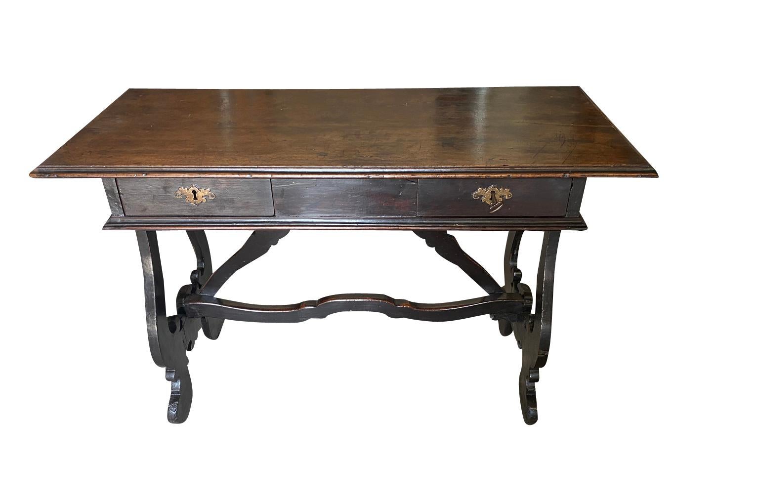 A very lovely 18th century Writing Table - Desk from Bologna, Italy.  Wonderfully constructed from handsome walnut with a conforming solid board top with handsome edge finish over  drawers, classical lyre legs and sculpted stretcher.  Fabulous