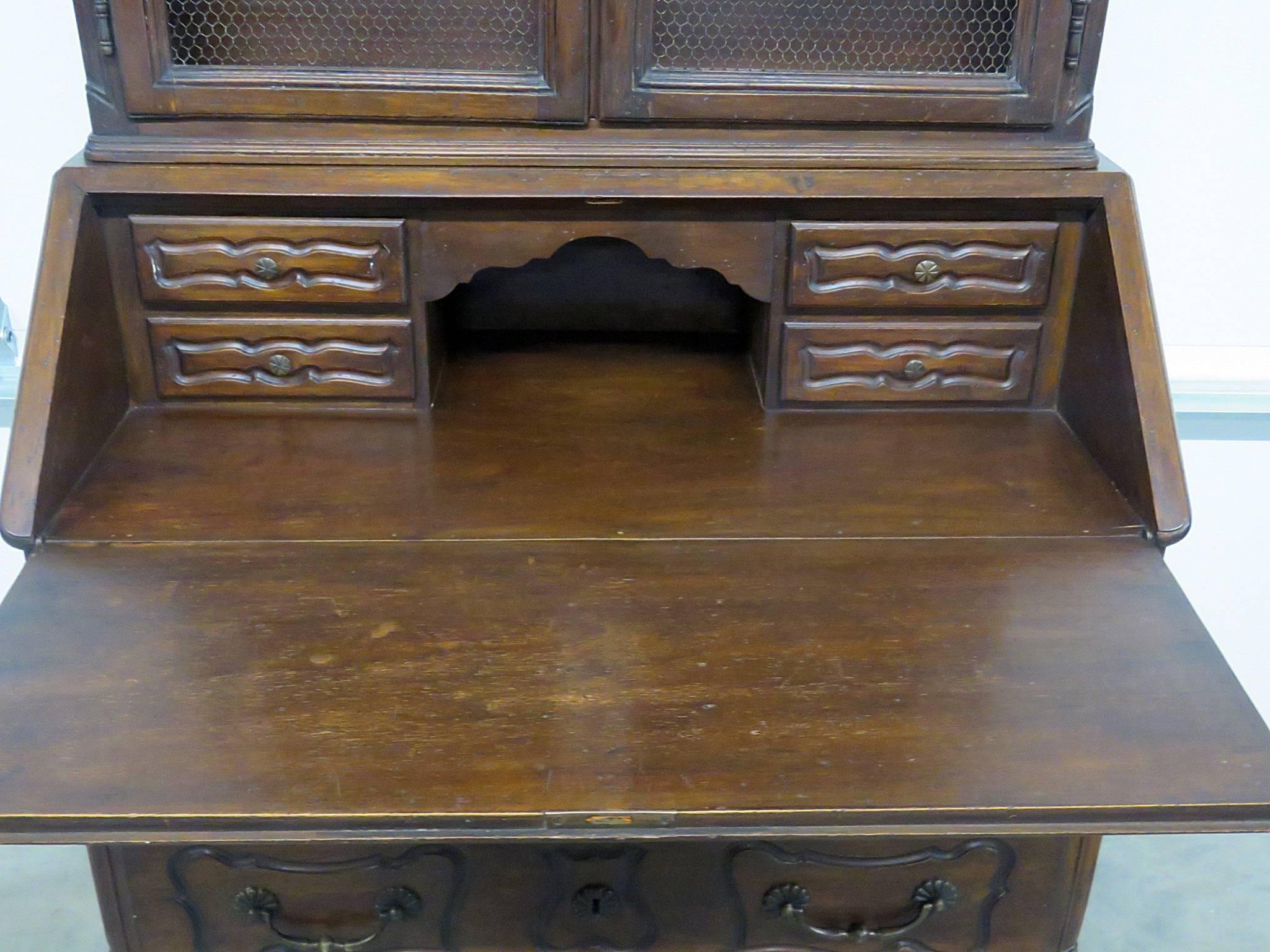 Italian 18th century country French mahogany secretary desk. Two-piece with two doors, two shelves, drop down desk with four drawers over two drawers.