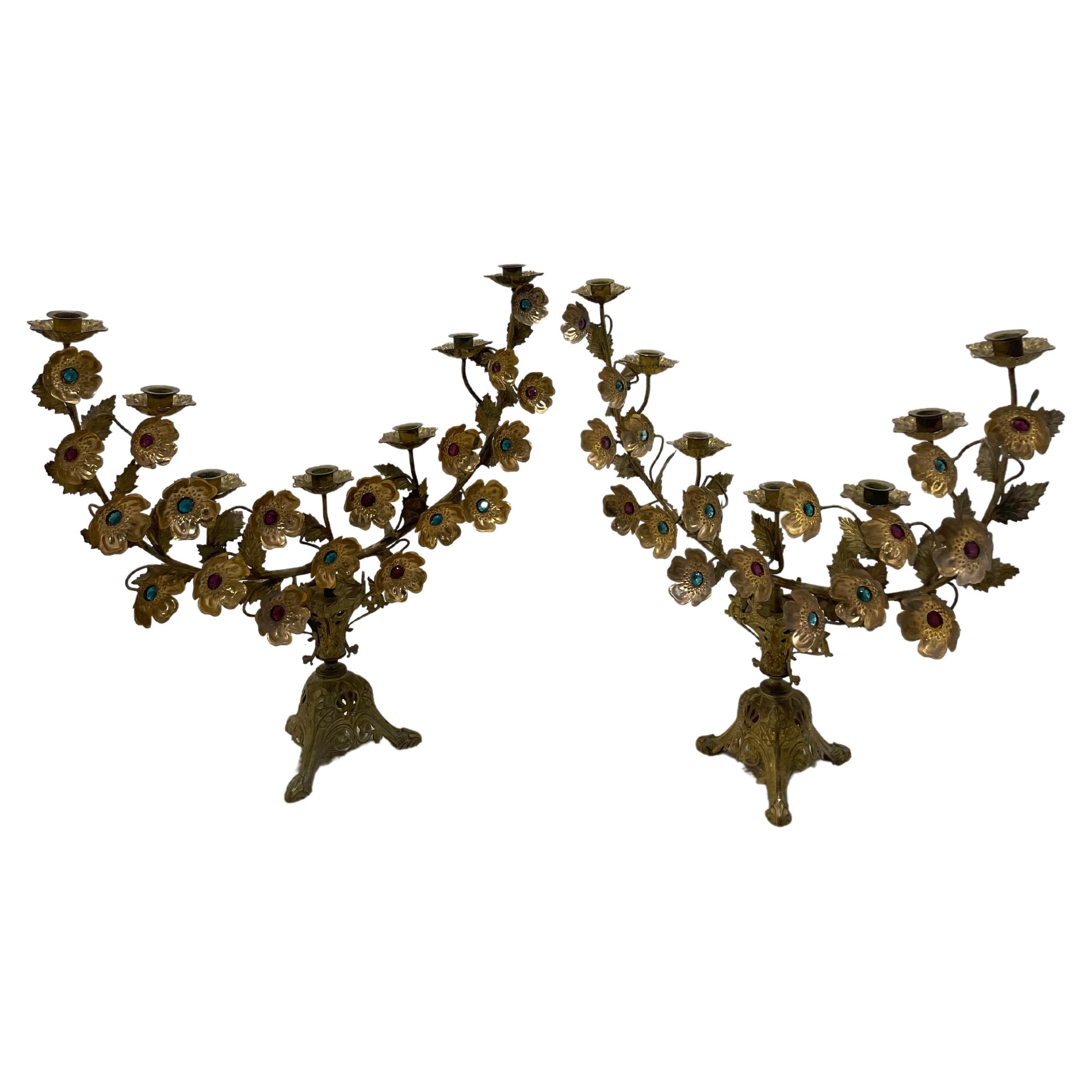 Spectacular pair of gilded bronze candelabre. Seven candles can go on each candelabra, the decorations delicat of flowers with stones of colors in glass, gives all the charms of the Italian baroque.