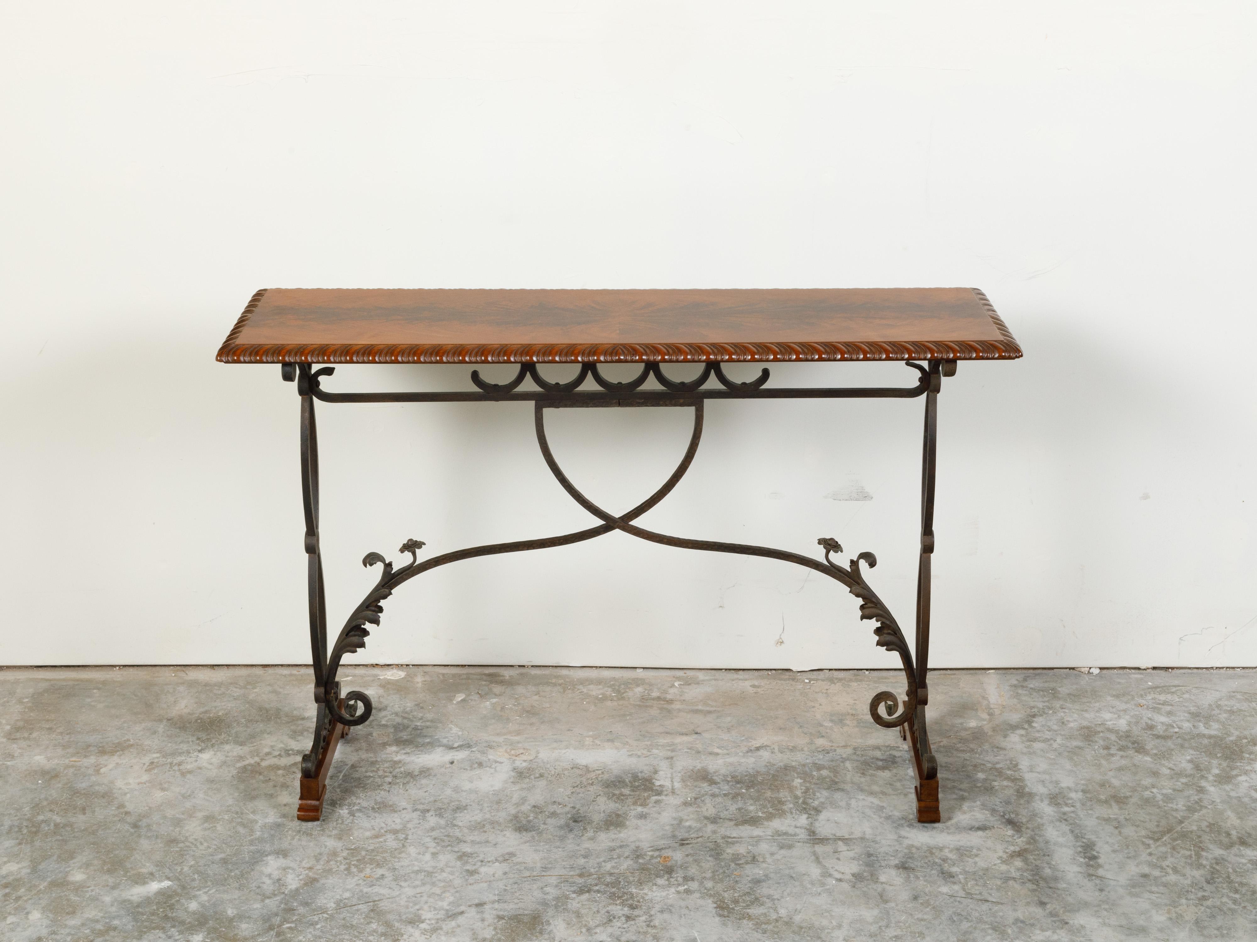 An Italian console table from the early 20th century, with walnut butterfly veneered top and iron scrolling base. Created in Italy during the early years of the 20th century, this console table features a handsome walnut top with butterfly veneer