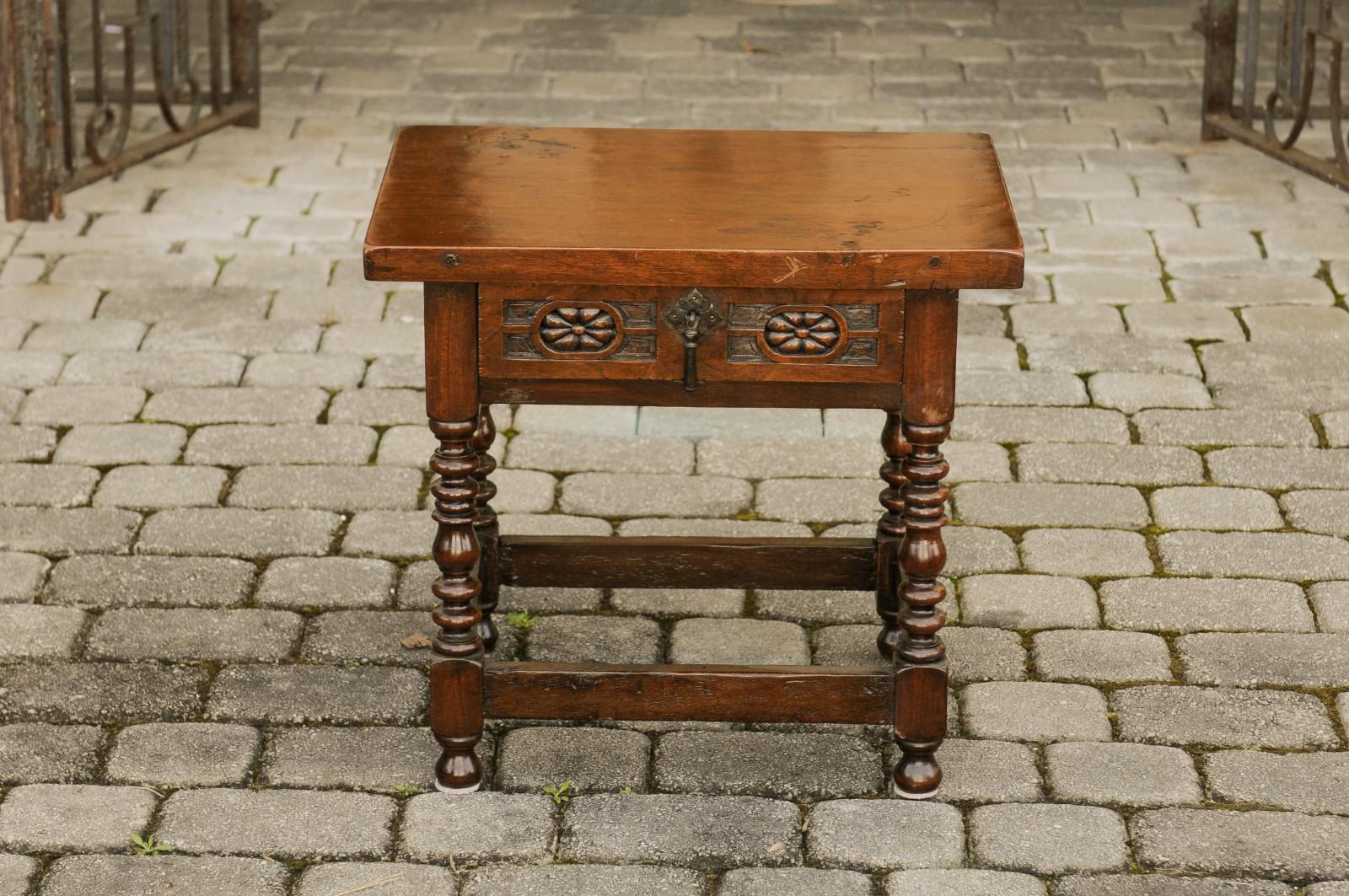 An Italian walnut side table from the early 20th century, with single drawer, floral décor and turned legs. Born in Italy during the early years of the 20th century, this lovely walnut side table features a rectangular top, sitting above a single