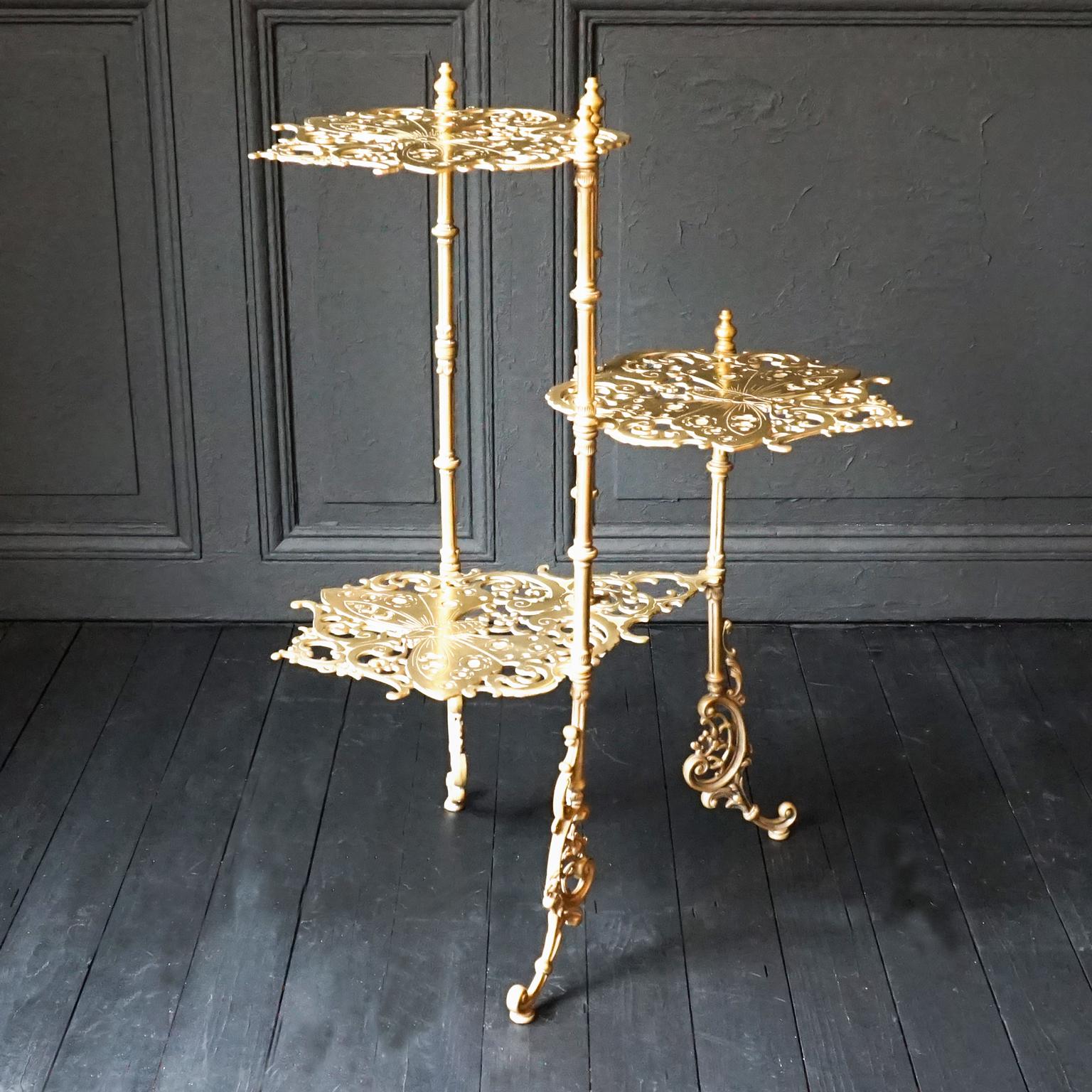Exceptional Jugendstil 3-tier solid cast brass plant Stand.
Finely detailed in ornate flower theme with butterfly design in the tier platforms. 
This Jugendstil but also very Hollywood Regency style stand will work in any interior. 
Of course it