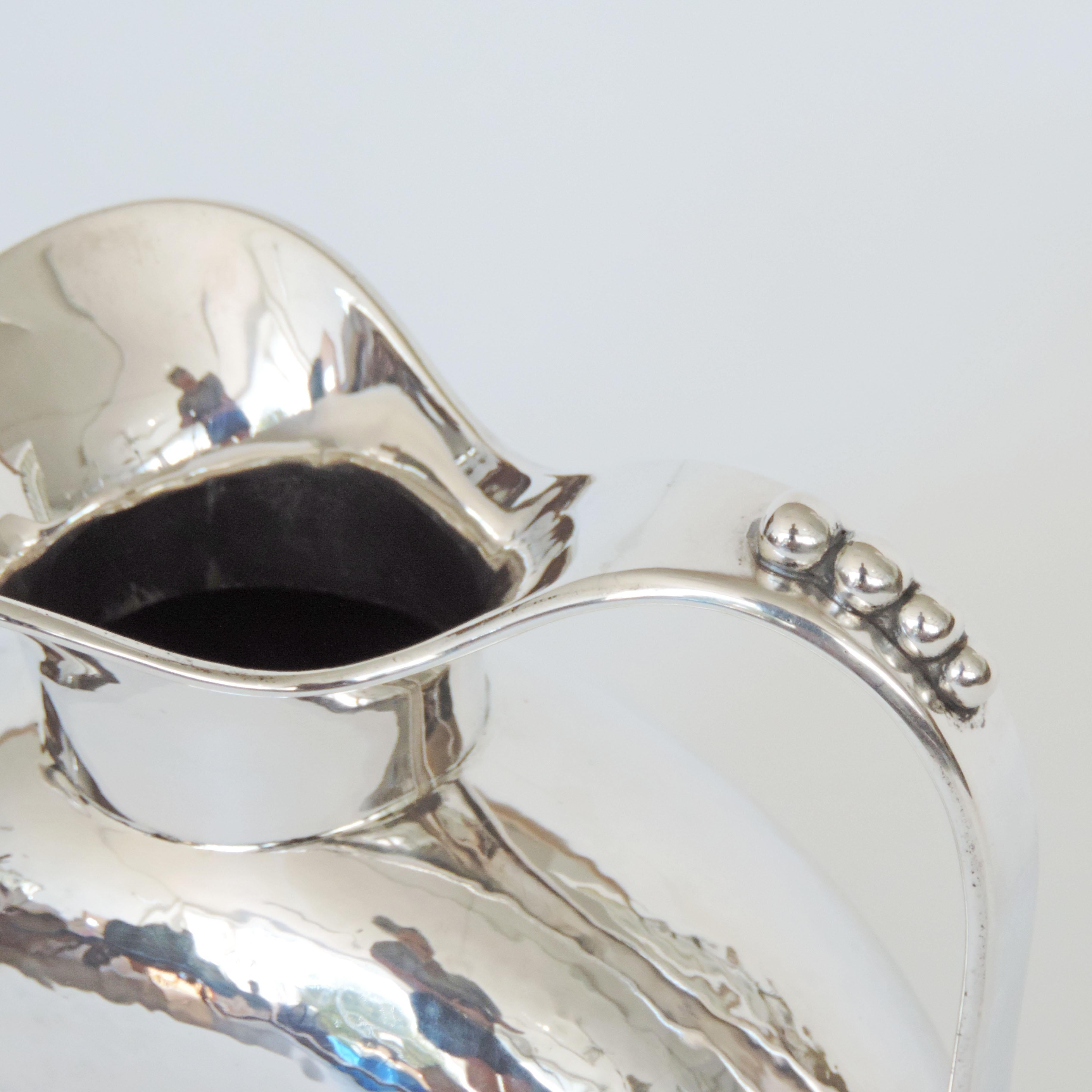 Italian 1930s Art Deco hammered silver jug
Signed 800 and Undecipherable Hallmark.