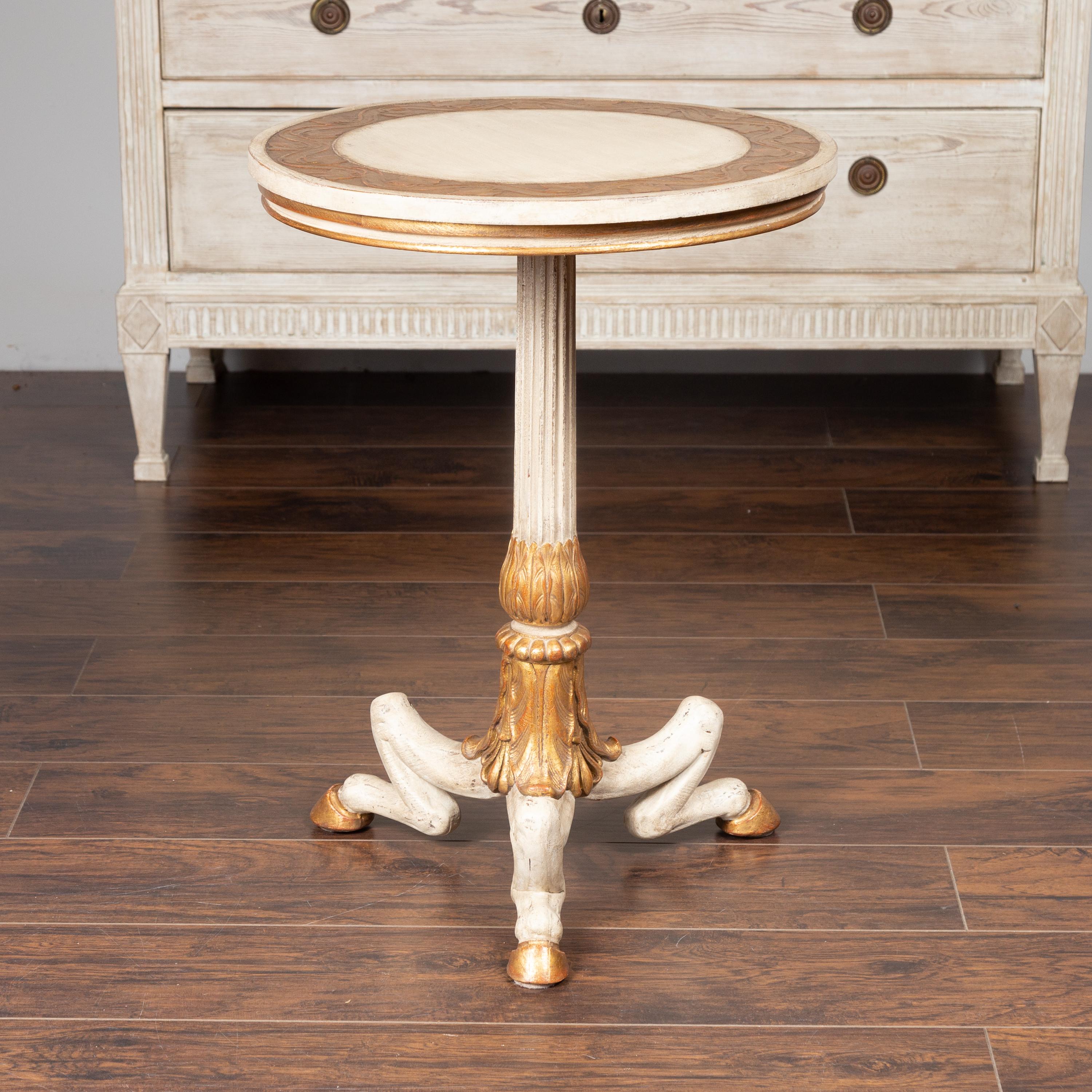 An Italian painted wood guéridon side table from the mid-20th century, with gilded accents and hoof legs. Born in Italy during the first half of the 20th century, this unusual guéridon captures our attention with its delicate contrast of colors and