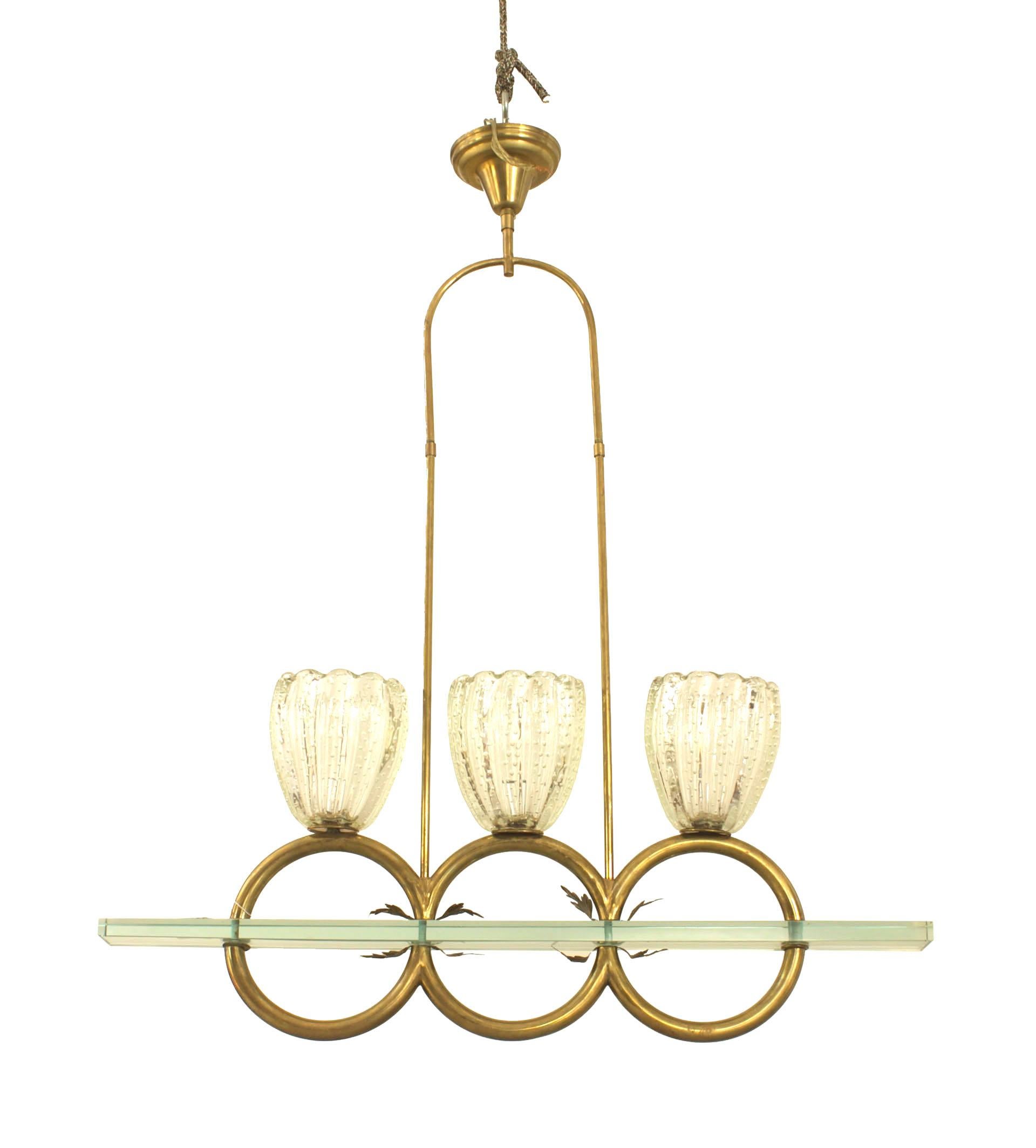 Italian Mid-century (1940ss) chandelier with 3 large fluted clear glass shades supported by 3 consecutive brass ring arms suspended from a narrow glass panel. (by Barovier ET Toso).
  