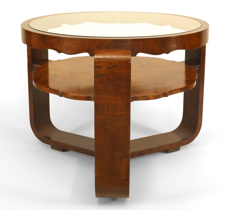 Italian Mid-Century (1940s) round burl walnut coffee table with a glass top, scalloped apron and shelf, and three legs meeting to form a stretcher base.
