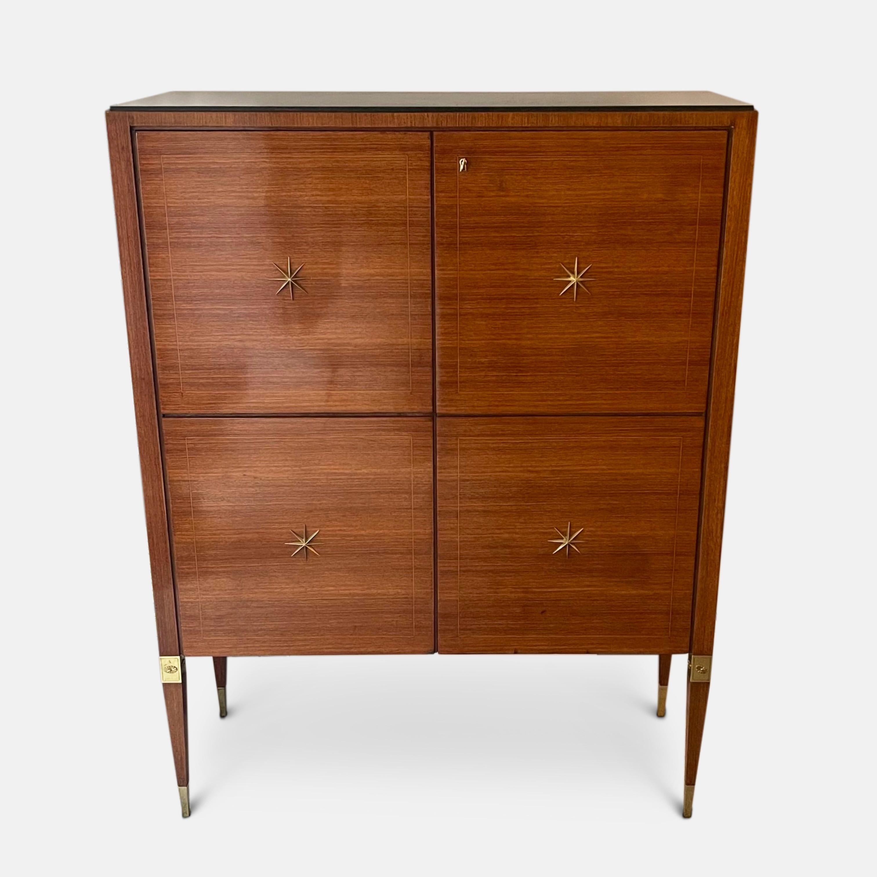 A fine 1940s Italian cabinet by Paolo Buffa 
Resting on slender tapered legs with deep brass sabot feet. This piece has wonderful four panelled doors finished in horizontal book matched veneer, each panel is surrounded with the subtlest band of
