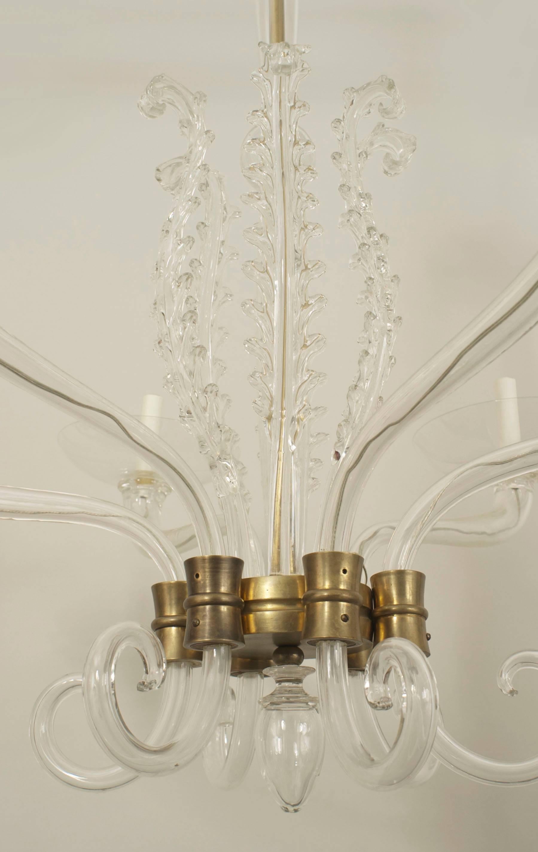 Italian 1940s clear glass chandelier with six scroll arms holding bowl shades connected with a bronze frame and a centerpost surrounded by vertical feathers with a finial bottom (by Venini).

 